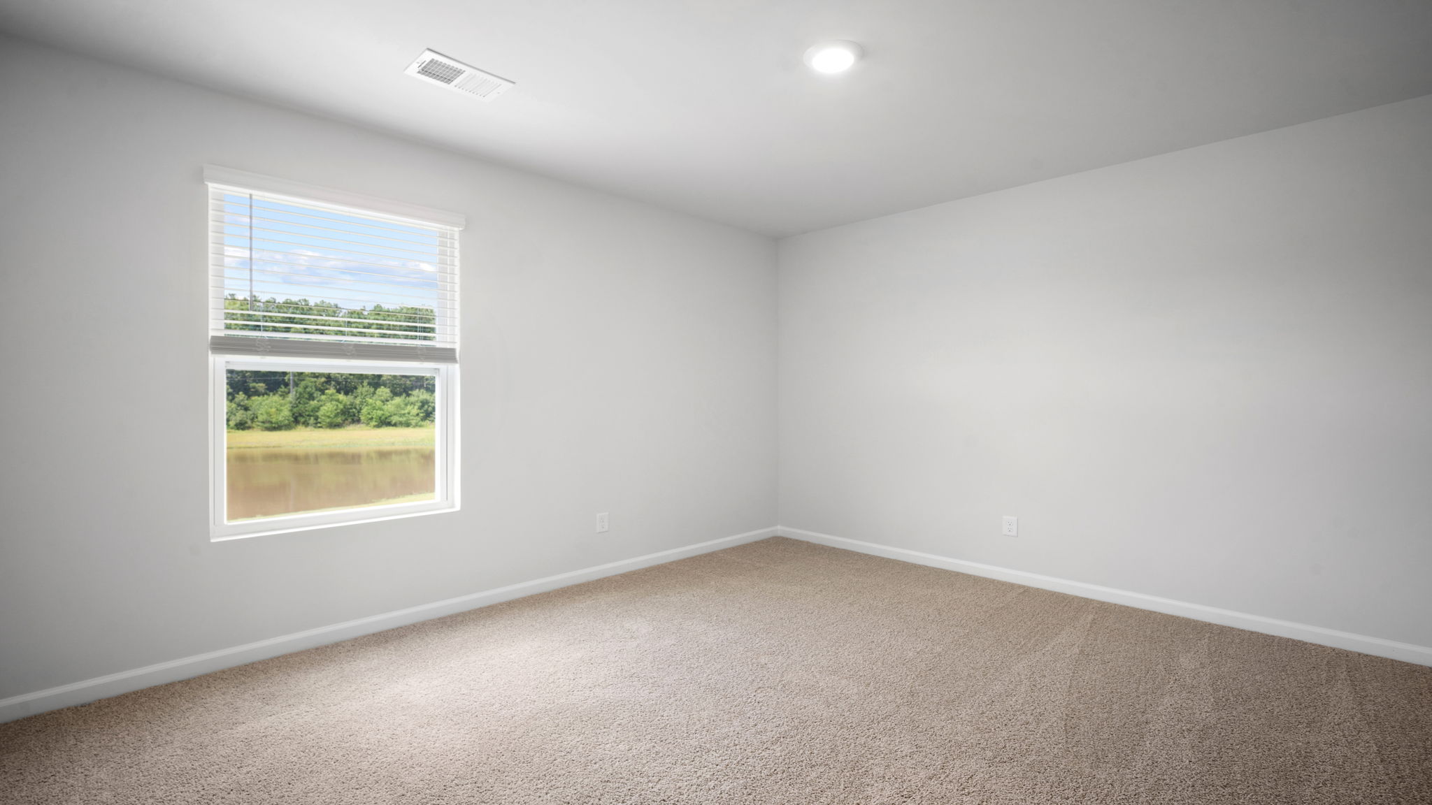 Comfortable guest bedroom in the Elston floorplan featuring natural light, ample closet space, and versatile living options for family, visitors, or a home office.
