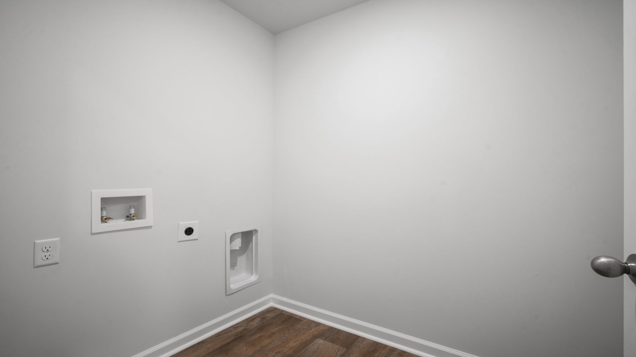 Dedicated laundry room in the Elston floorplan featuring convenient utility space, storage opportunities, and practical functionality for busy households.