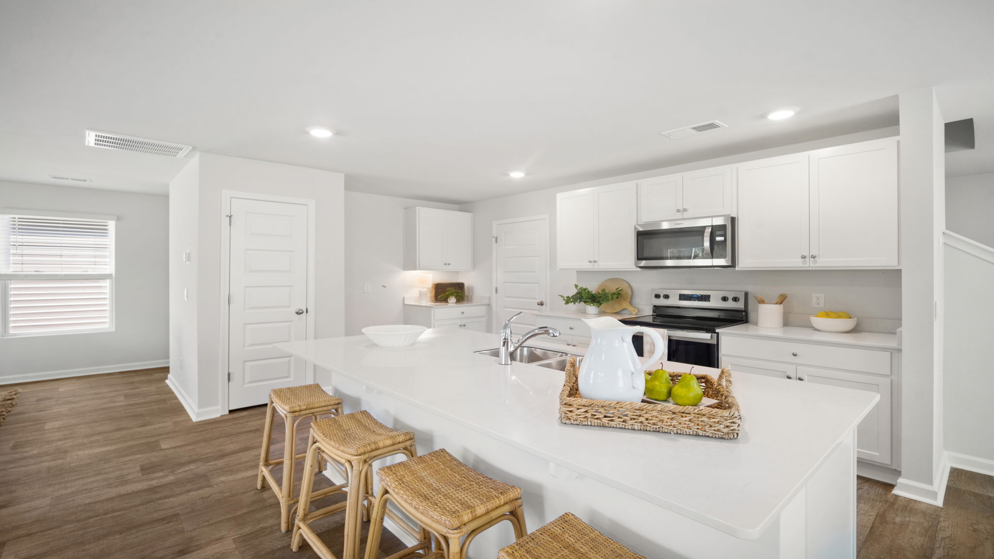 Spacious kitchen in the Elston floorplan designed for gathering with family and friends while providing functionality, style, and ample workspace.