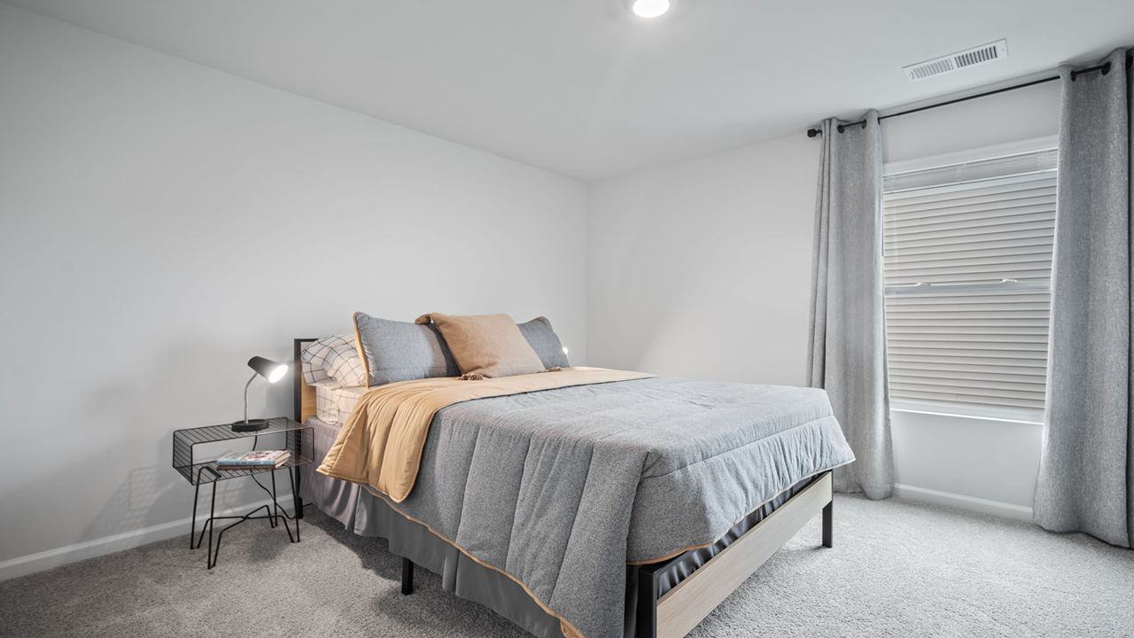 Guest bedroom decorated with a bed and table