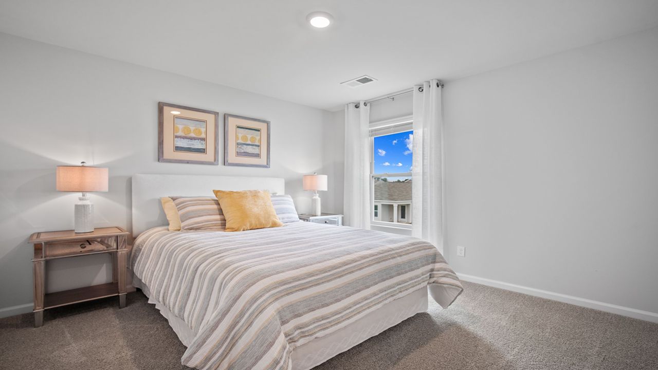 Guest bedroom decorated with a bed and a side table