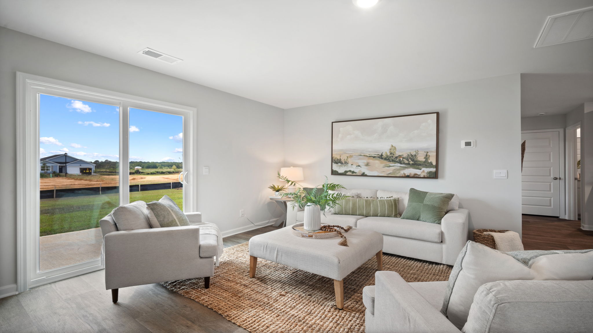 Open living room in Robie floorplan connecting kitchen and dining areas for modern everyday living