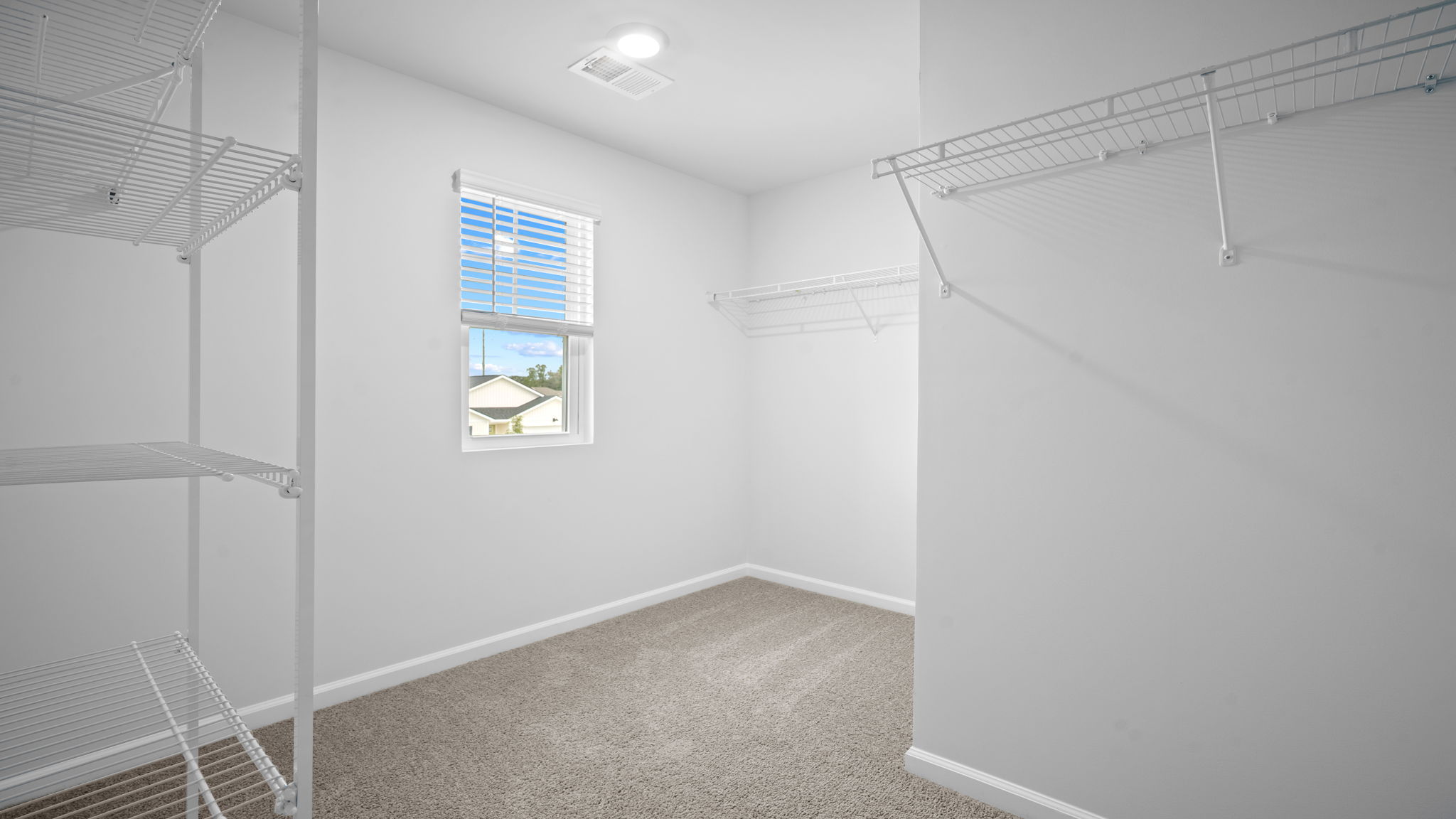 Walk‑in closet in Robie floorplan primary suite offering generous storage space