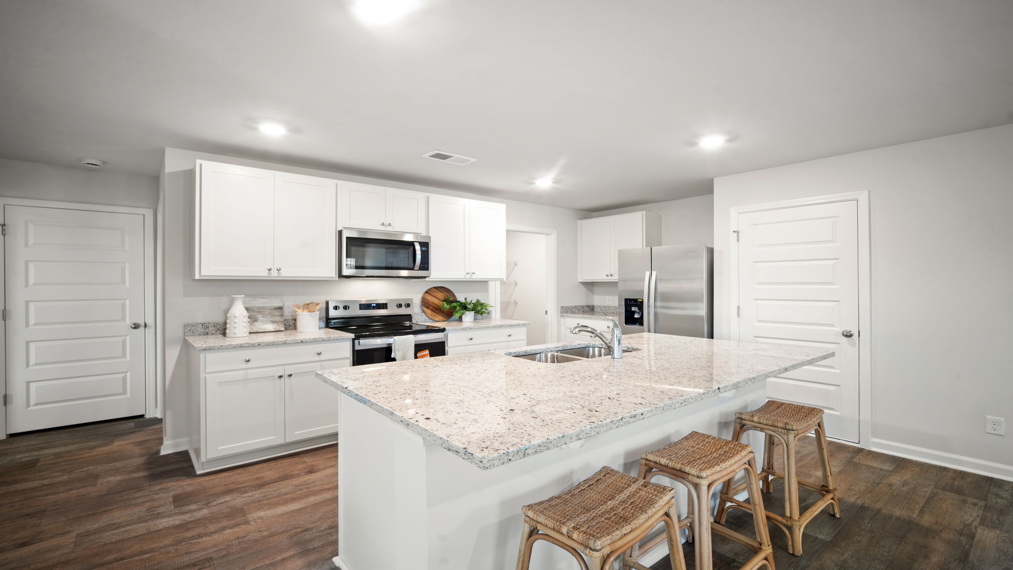 Robie floorplan kitchen with large center island, stainless steel appliances, and open‑concept layout in Rice Hope
