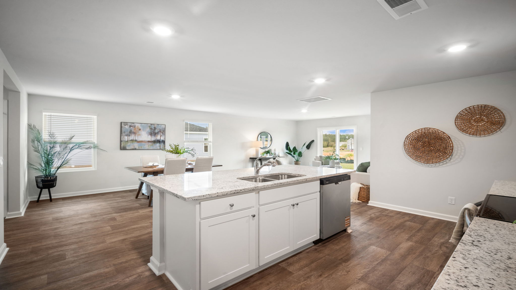 Robie floorplan kitchen with large center island, stainless steel appliances, and open‑concept layout in Rice Hope