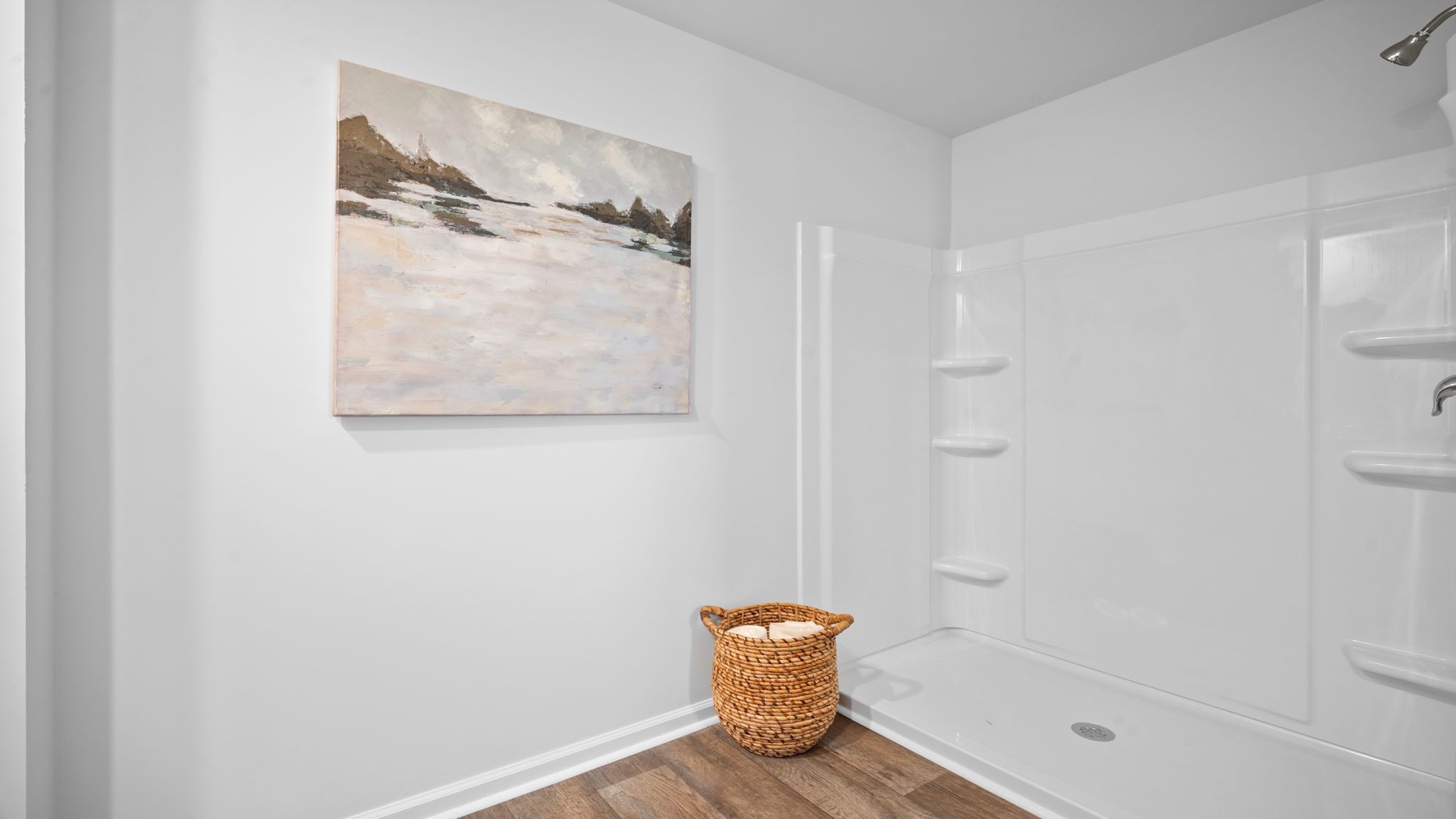 Primary bathroom with toilet and wall decor.