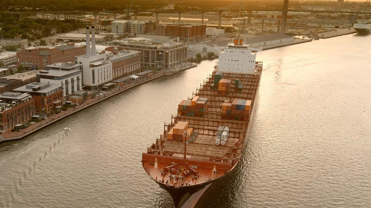 Downtown Savannah bridge view over river with port ship