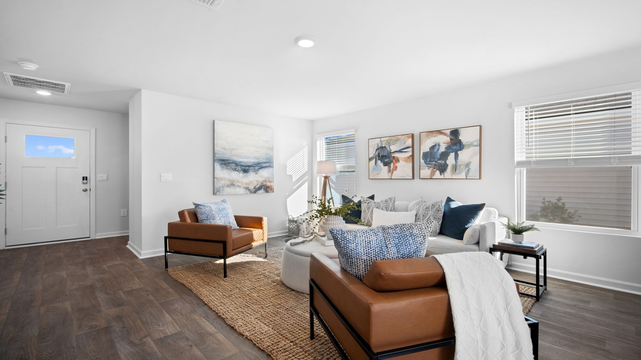 Living area of home decorated with seating and tables