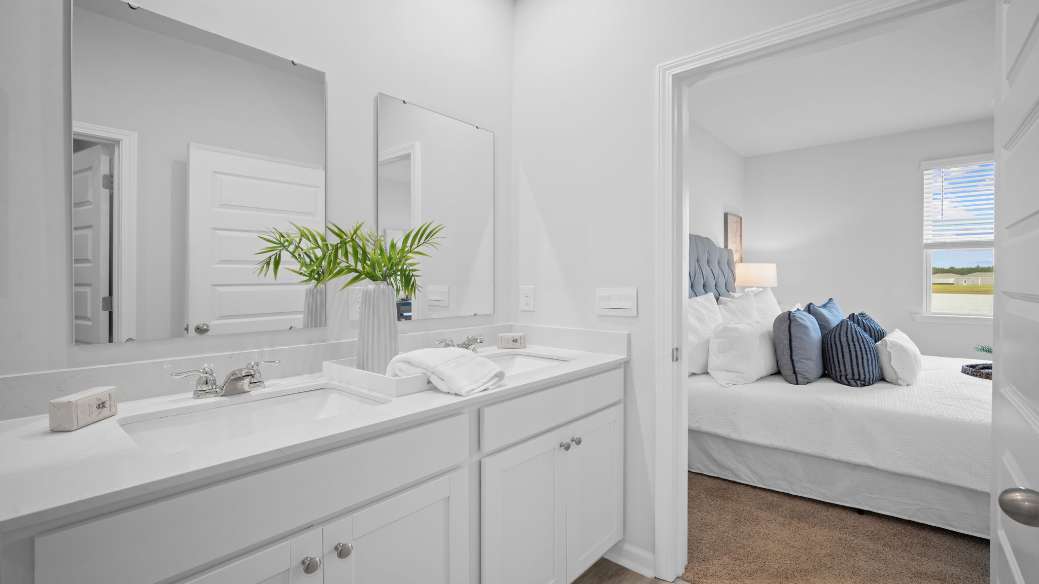 Primary bathroom with double vanities and a stand-up shower