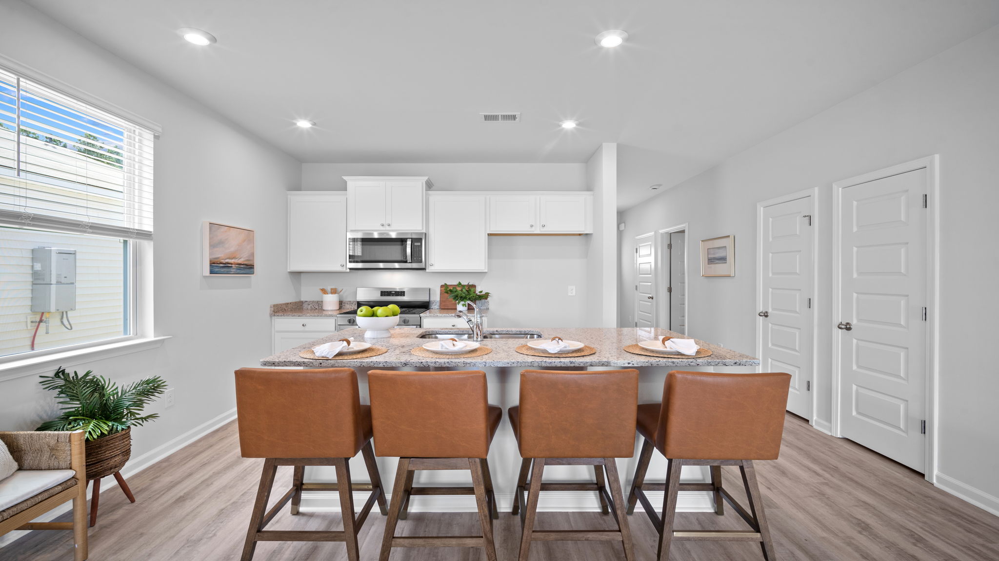 Gourmet kitchen featuring oversized island, stainless steel appliances, walk-in pantry, and abundant cabinet space.