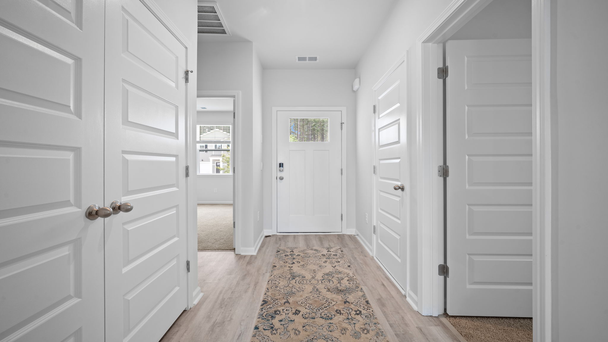 Bright foyer entrance with open sightlines and elegant access to the main living areas.
