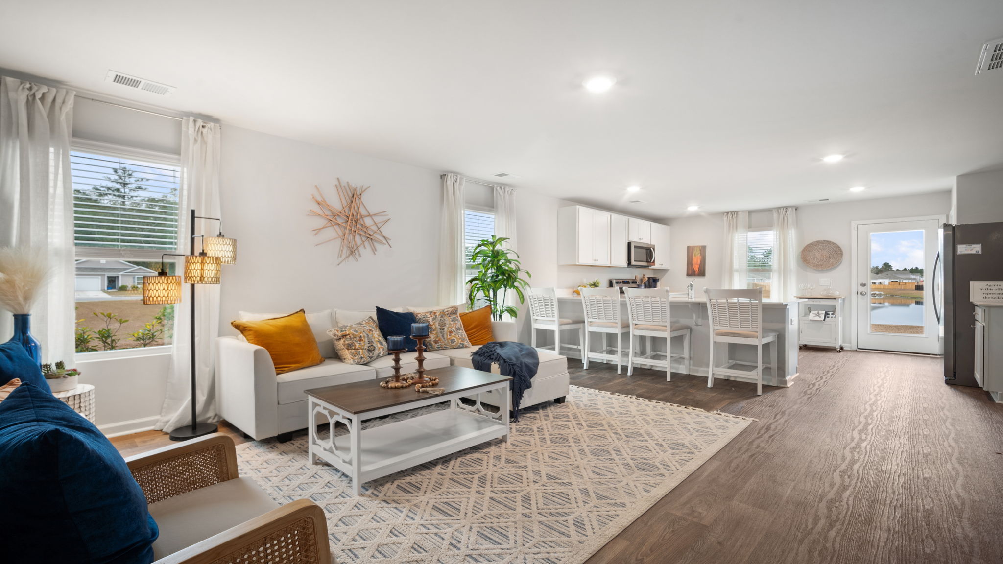 Open living room in Lewis floorplan at Rice Hope connecting kitchen and dining area for easy, modern living