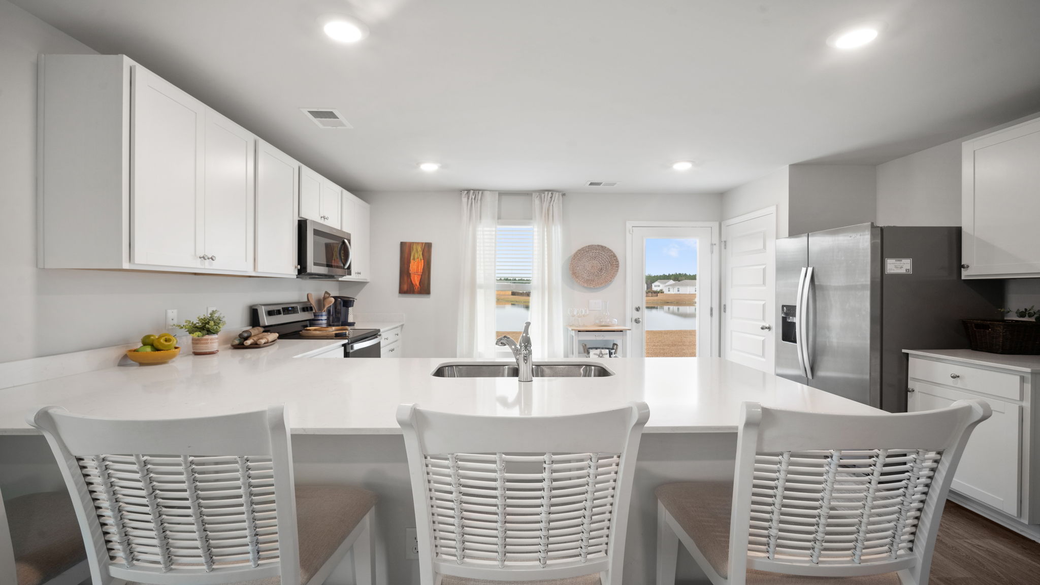 Bright kitchen in D.R. Horton Lewis home overlooking living space, perfect for entertaining and everyday living