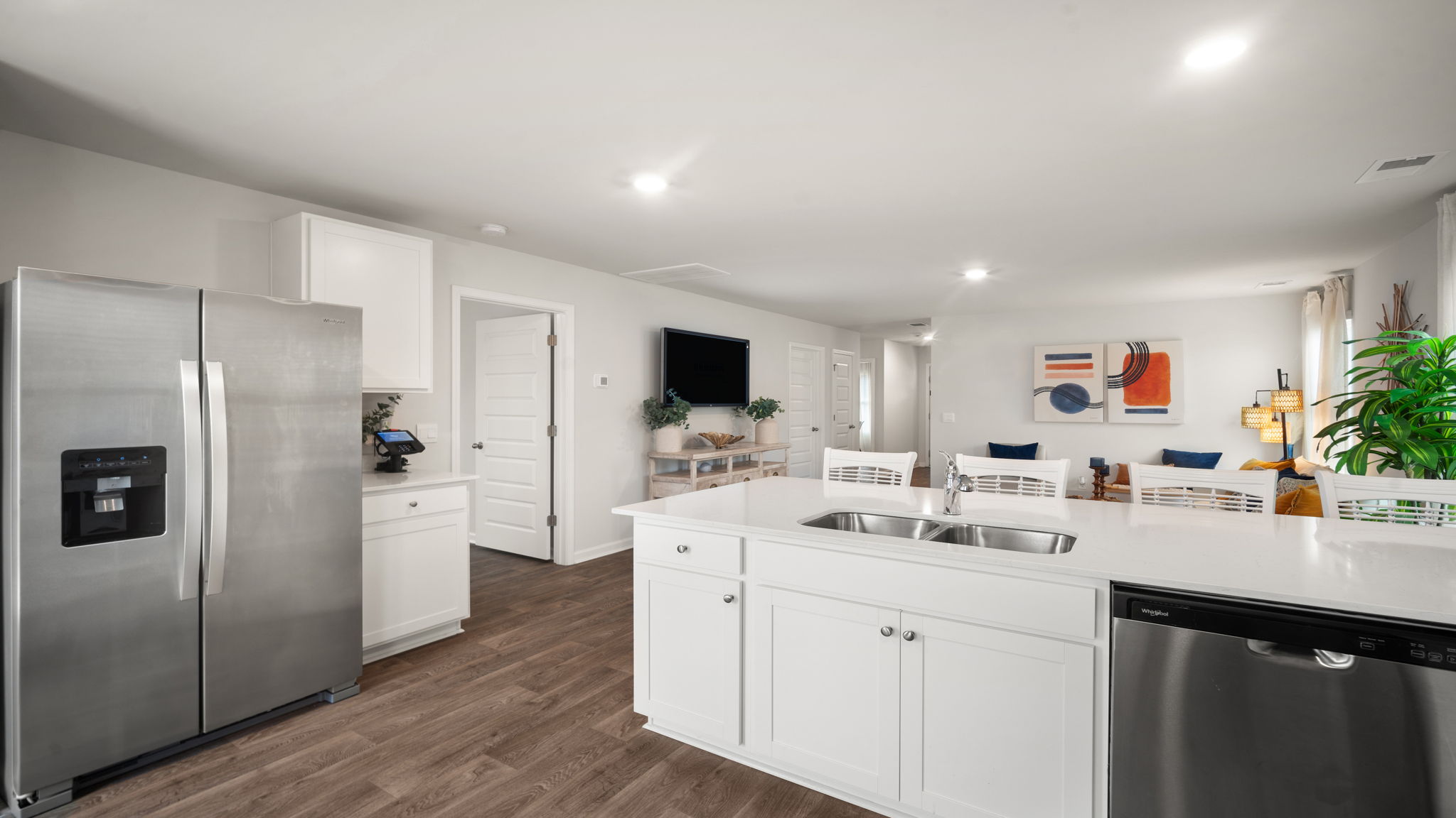 Lewis floorplan kitchen with open-concept design, ample cabinetry, and seamless flow to living area in Rice Hope