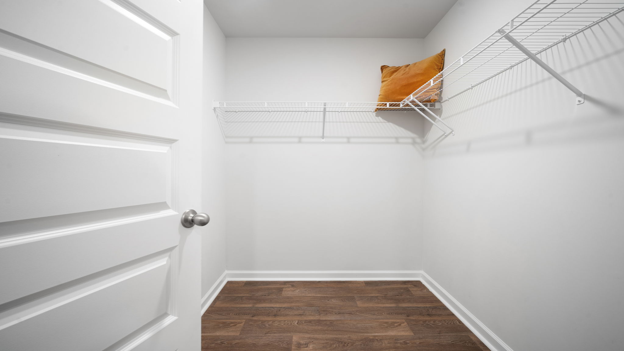 Walk-in closet in Lewis floorplan primary suite offering ample storage space