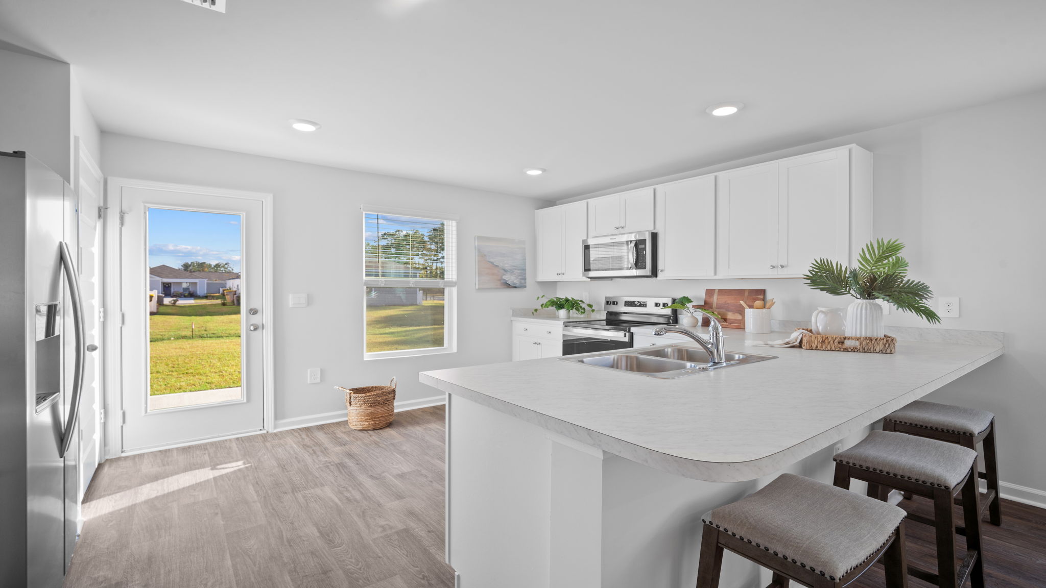 Open concept kitchen with view behind the island with living area.