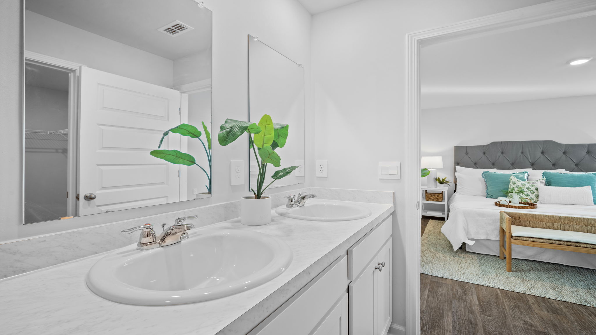 Beautiful primary bath in the Lewis floor plan by D.R. Horton in Rice Hope showcasing contemporary cabinetry, designer lighting, ample storage, and a thoughtfully designed layout that combines style and functionality.