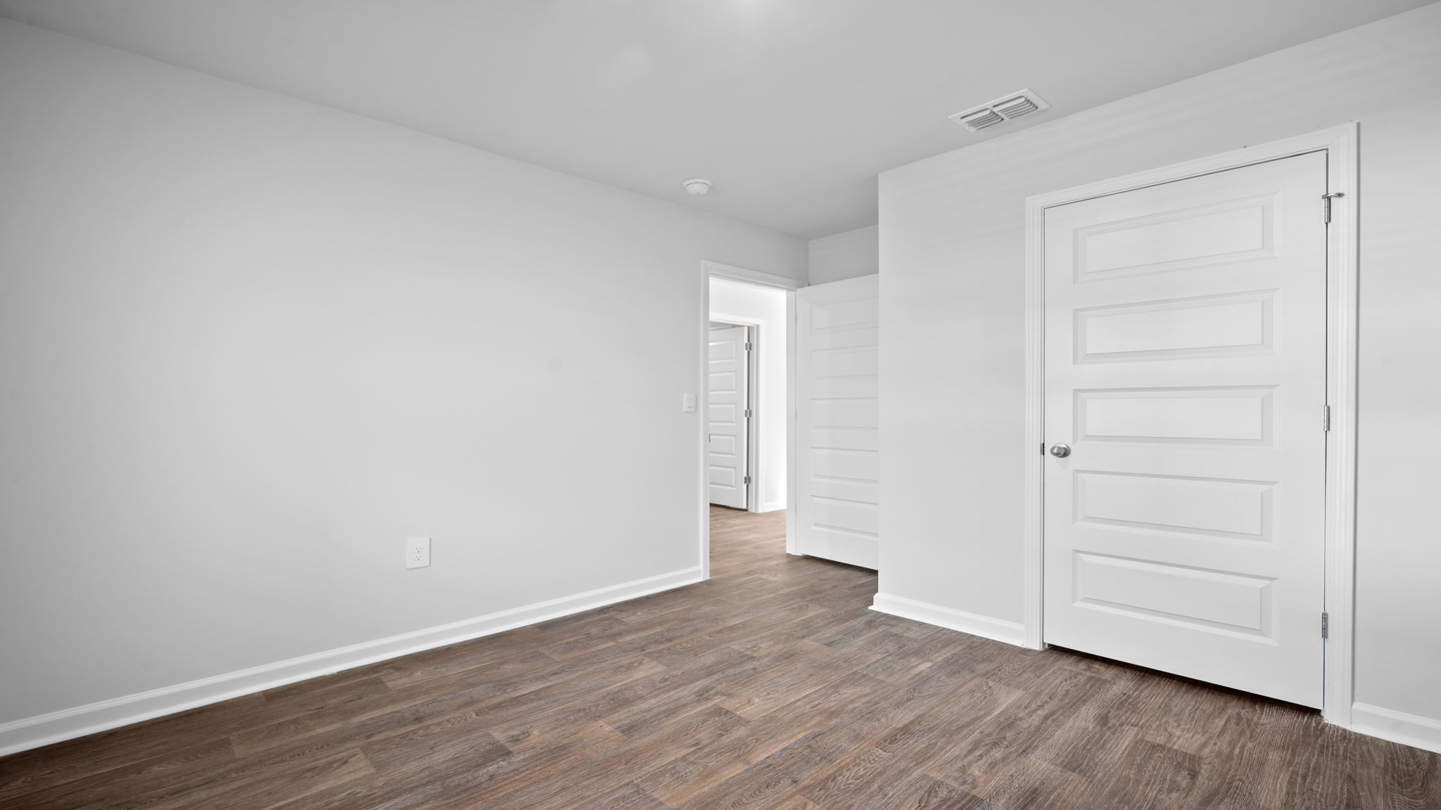 Comfortable guest bedroom in the Lewis floor plan at Rice Hope featuring spacious accommodations, abundant natural light, and flexible living space for visitors, family members, or a home office.