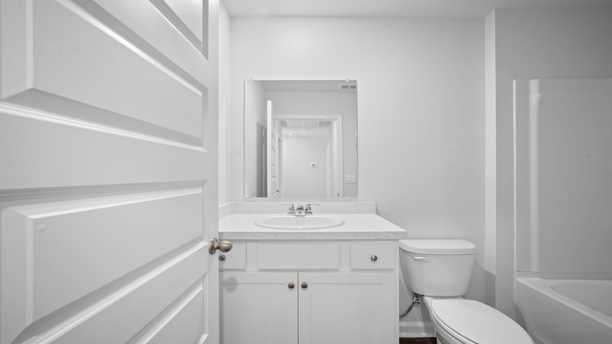 Beautiful guest bathroom in the Lewis floor plan by D.R. Horton in Rice Hope featuring modern fixtures, stylish cabinetry, bright lighting, and a functional layout designed for convenience and comfort.