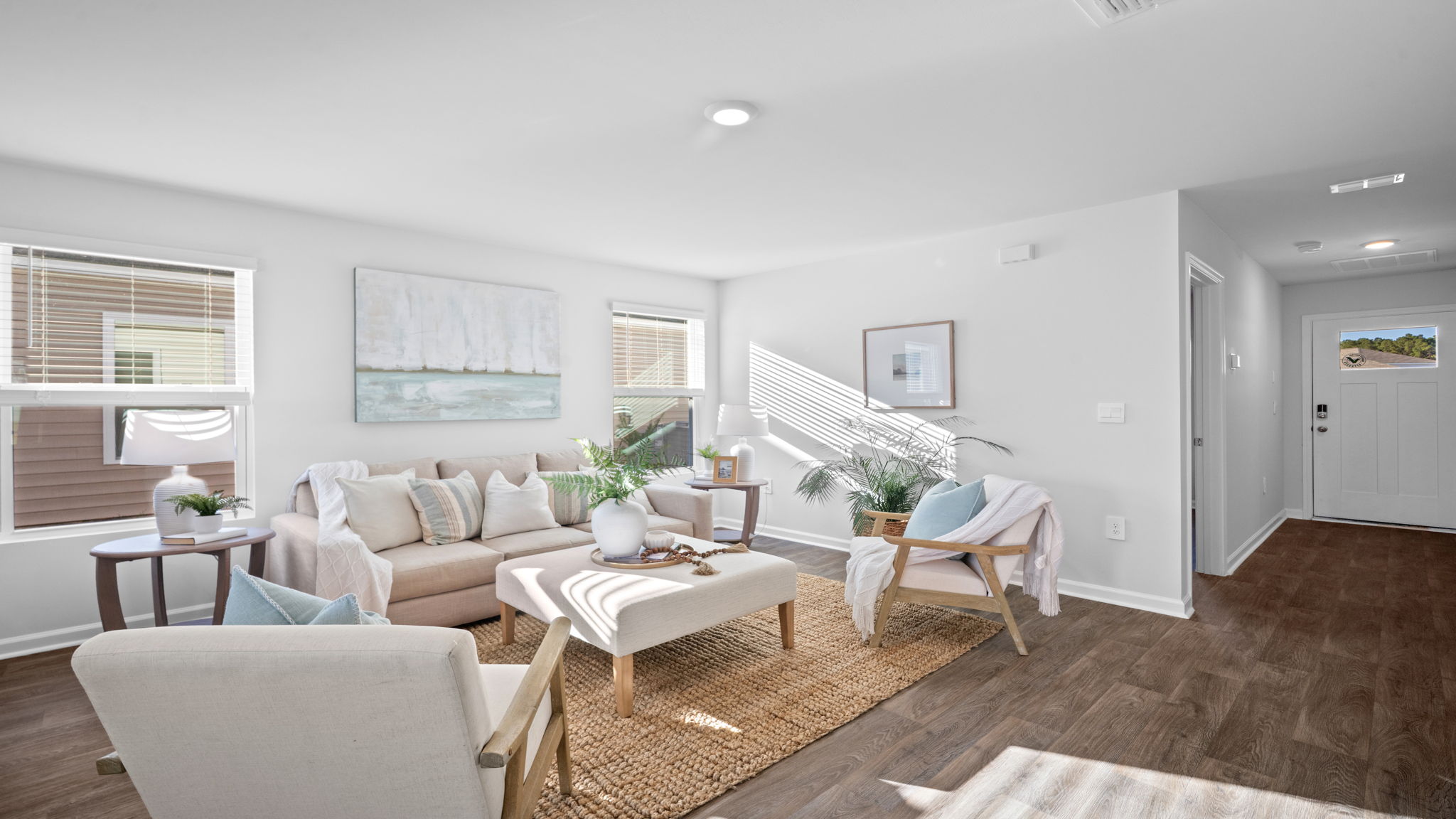 Spacious family room in the Lewis floor plan by D.R. Horton showcasing modern finishes, comfortable gathering space, and seamless connectivity to the kitchen and dining areas.