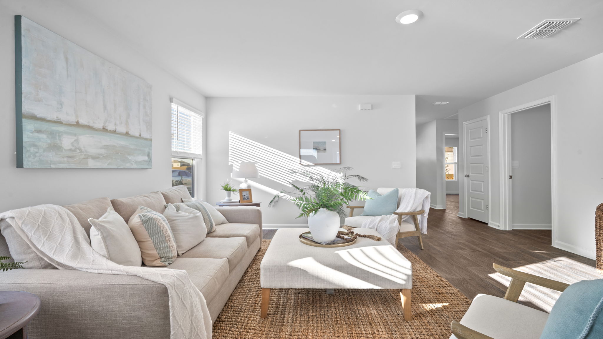 Open-concept living area in the Lewis floor plan at Rice Hope featuring expansive sightlines, contemporary design, and versatile space for entertaining, relaxing, and everyday living.