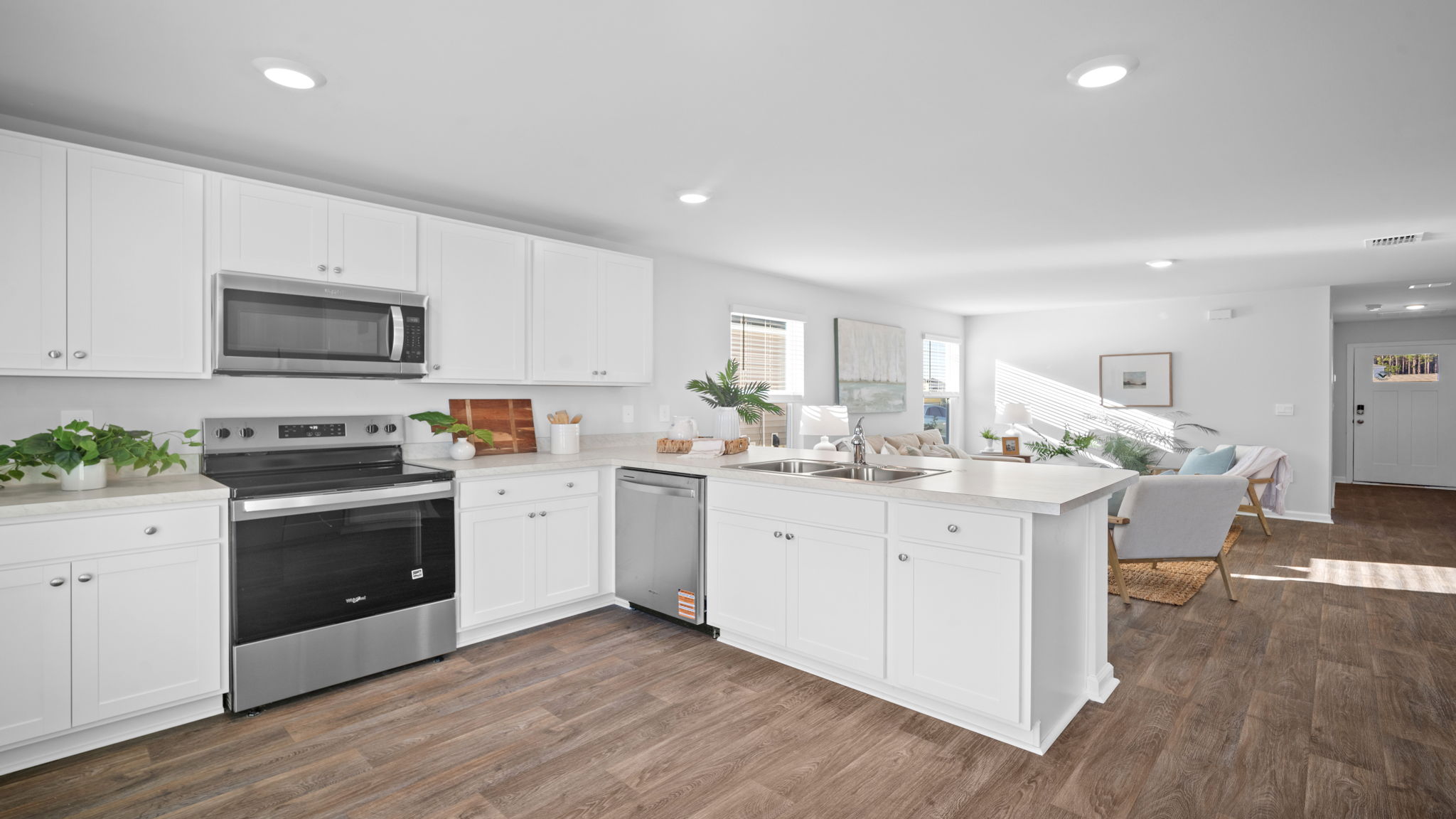 Chef-inspired kitchen in the Lewis floor plan at Rice Hope featuring stylish cabinetry, granite countertops, stainless steel appliances, pendant lighting, and an open design perfect for family gatherings.