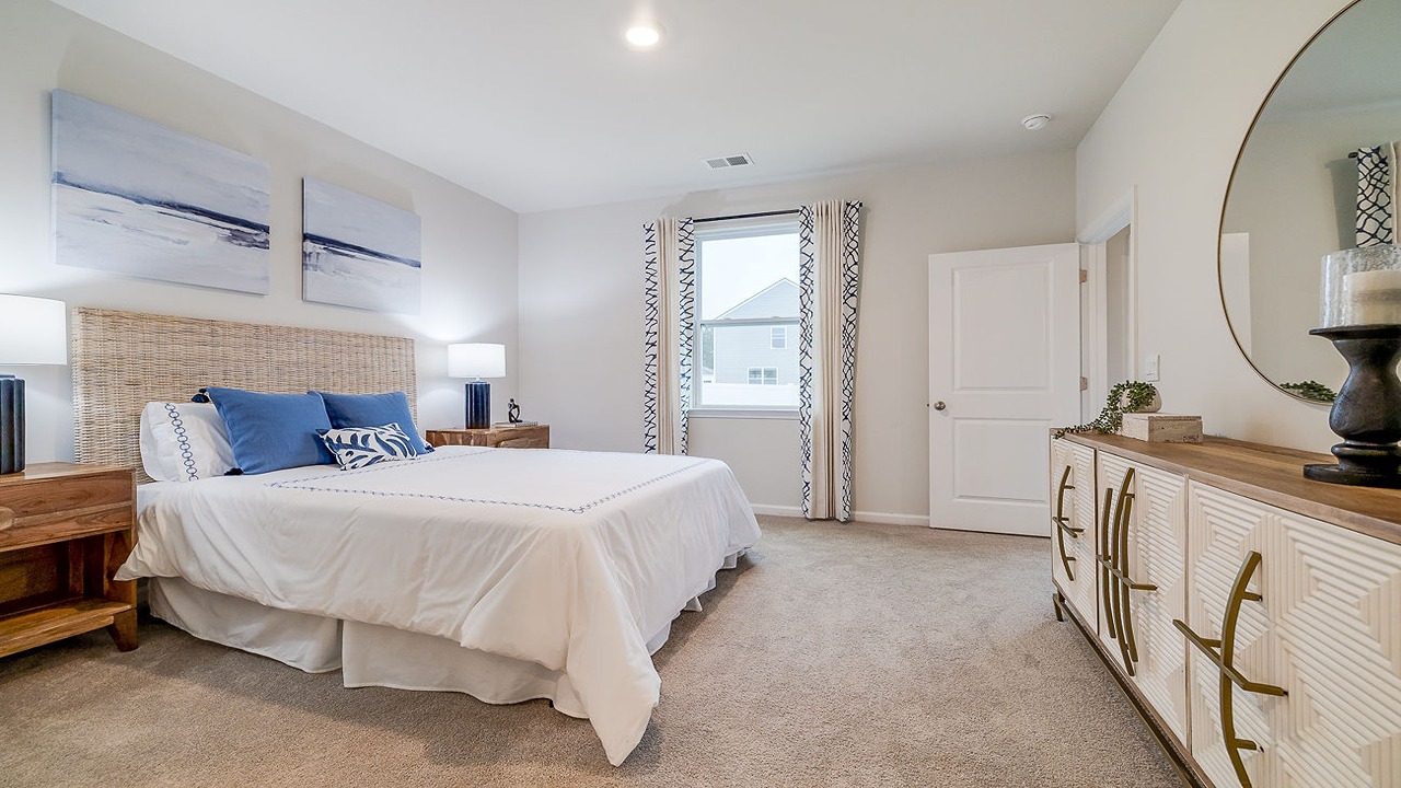 Private primary suite in the Helena floor plan at Rice Hope by D.R. Horton featuring spacious dimensions, abundant natural light, a walk-in closet, and a relaxing retreat-like atmosphere.