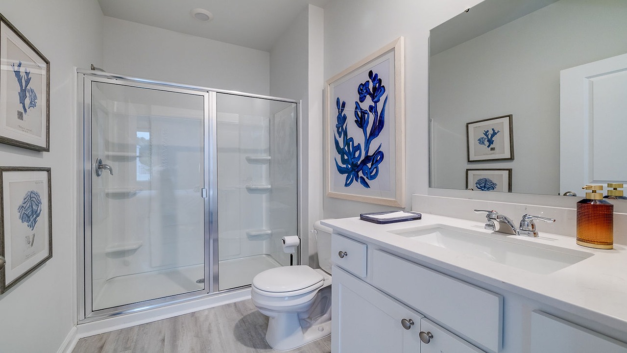 Luxury primary bathroom in the Helena floor plan at Rice Hope featuring a dual-sink vanity, spacious walk-in shower, modern fixtures, and designer-inspired finishes