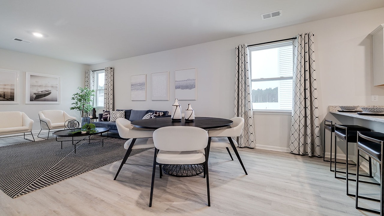 Elegant dining room in the Helena floor plan at Rice Hope by D.R. Horton featuring natural light, open-concept living, and easy access to the kitchen for effortless entertaining