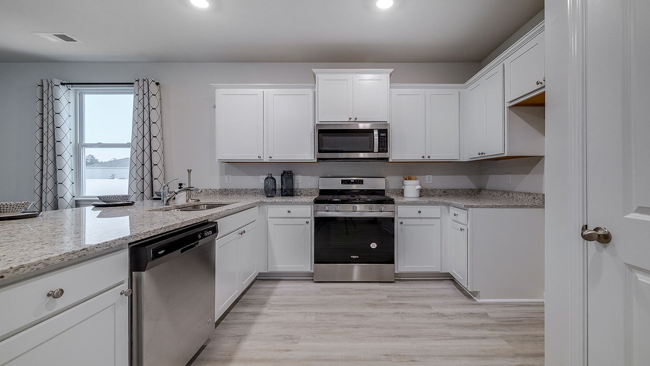 Beautiful kitchen in the Helena floor plan at Rice Hope offering modern finishes, ample prep space, stylish lighting, and an inviting design ideal for family gatherings and entertaining guests.