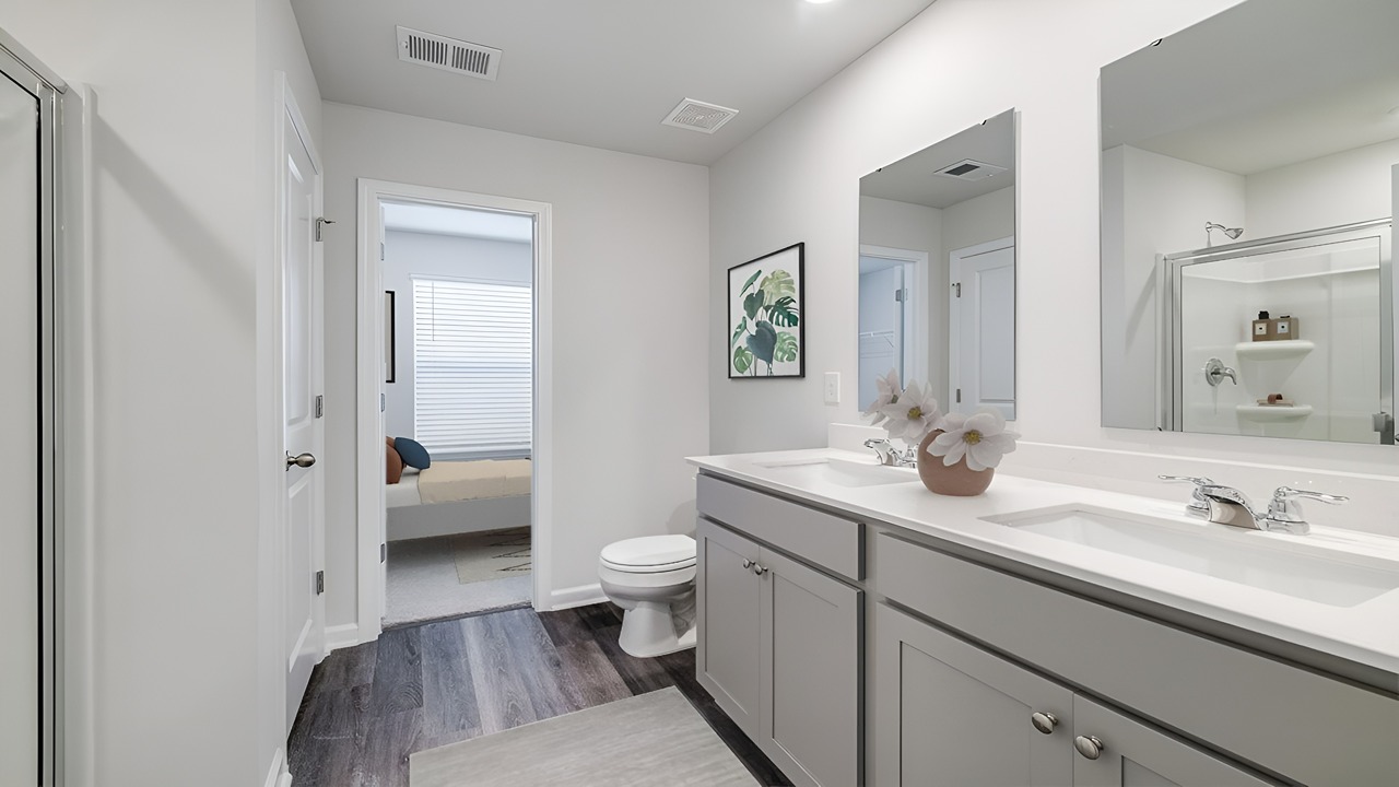 Primary bathroom with a double vanity and a stand-up shower