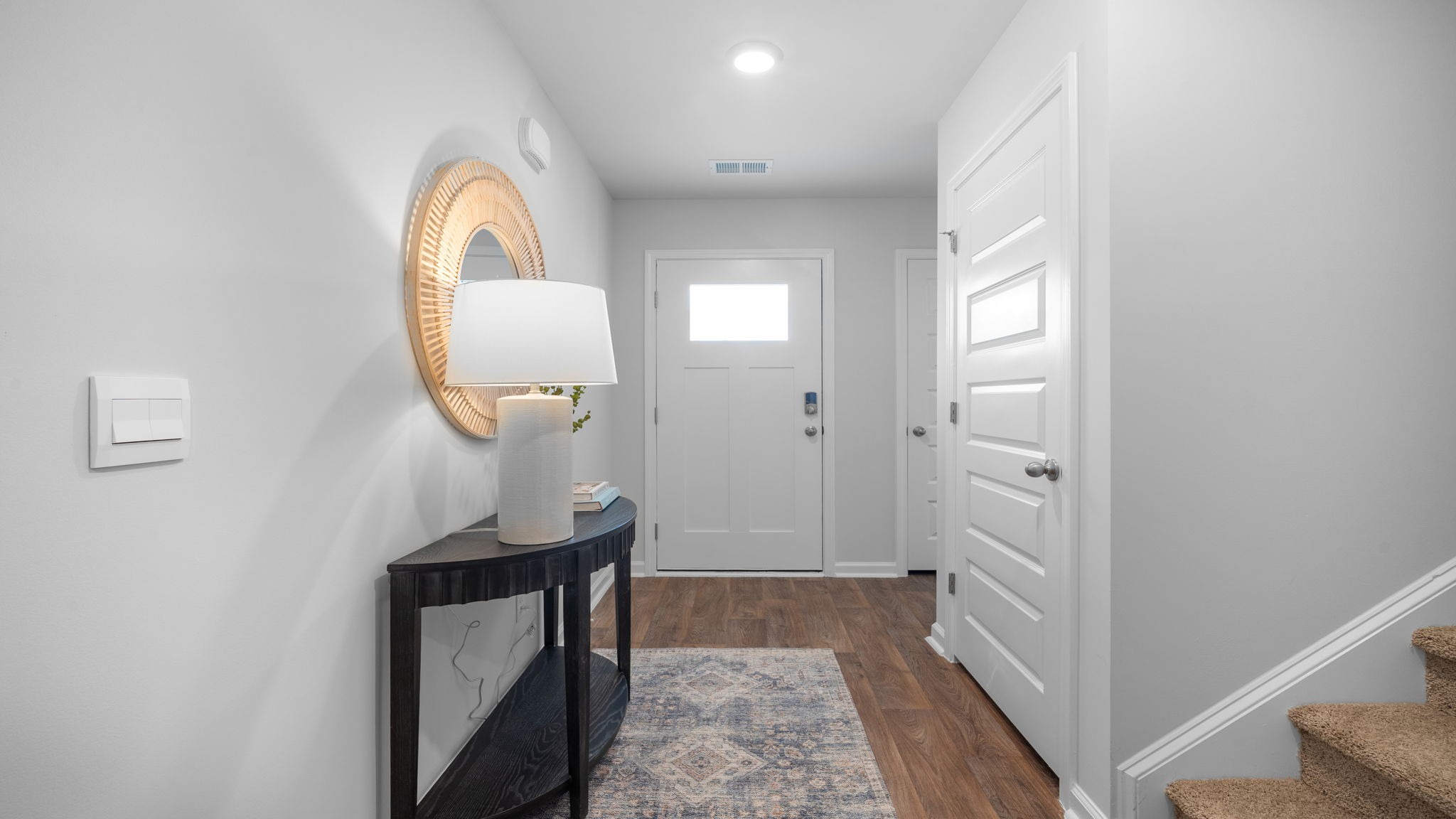 Welcoming foyer entry in the Hartsville floorplan by D.R. Horton with open sightlines leading into main living areas in Rice Hope Port Wentworth GA