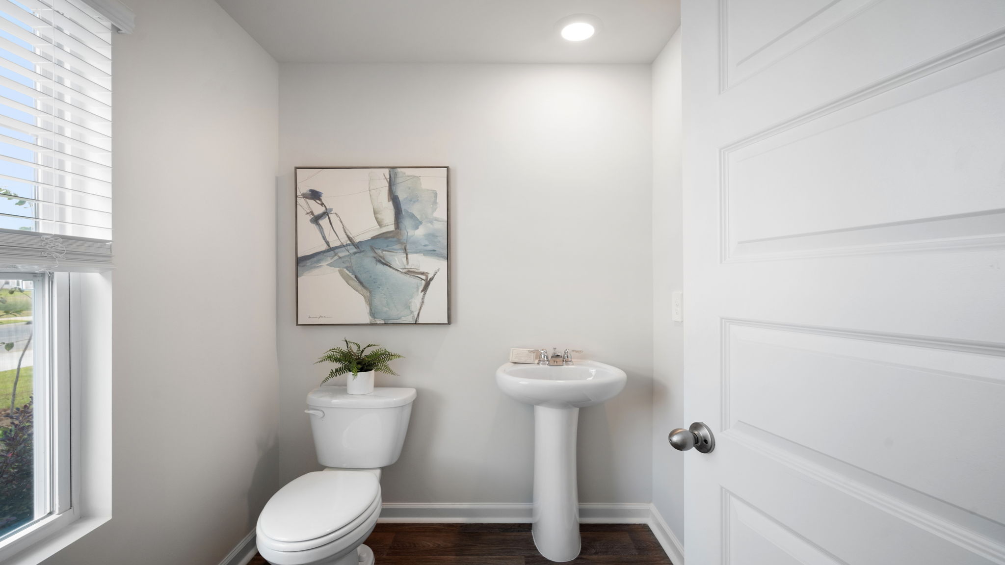 Half bathroom in the open concept living space.