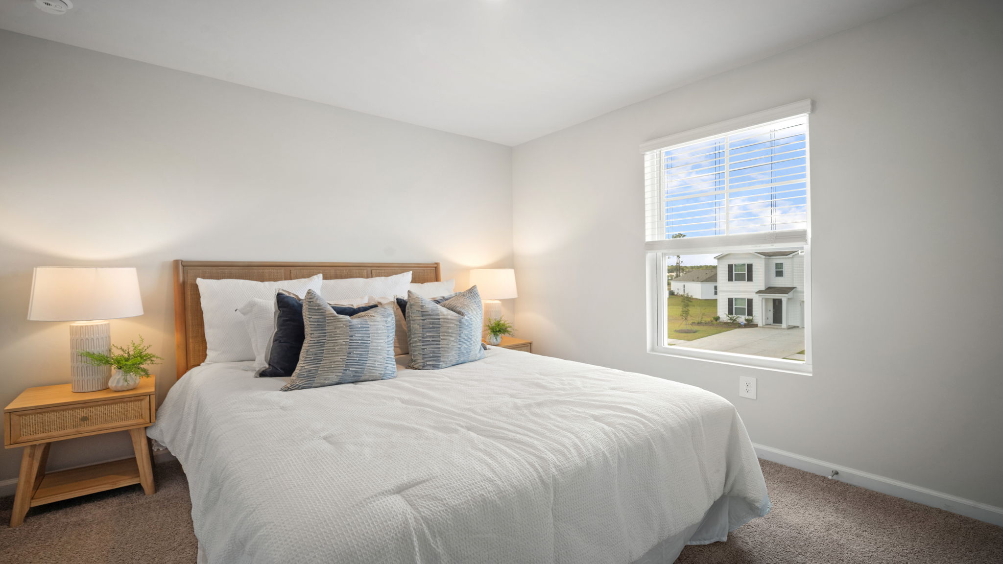 Bedroom with hardwood floors and large single window for natural light.
