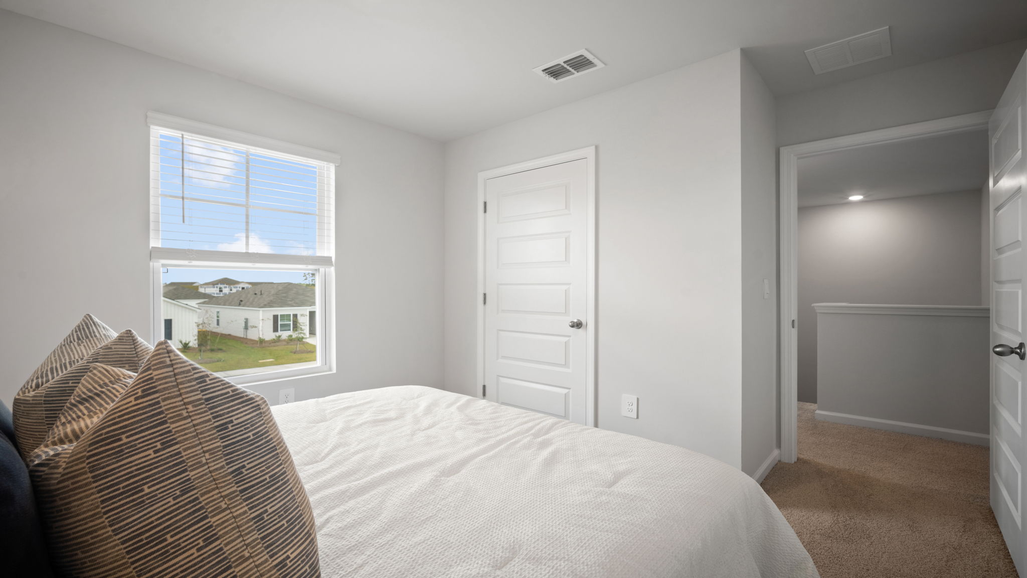 Bedroom with closet door and entry door.