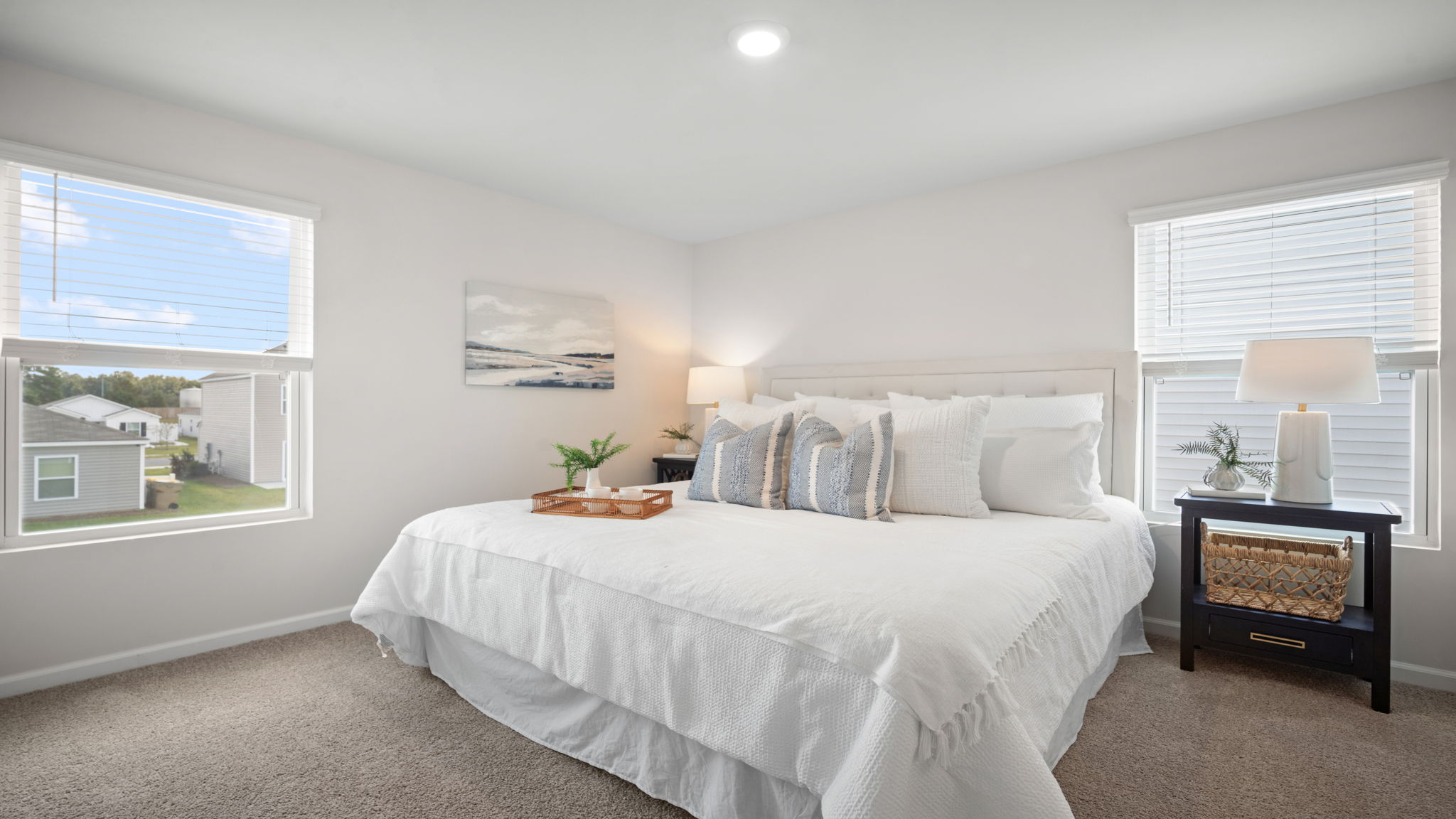 Primary bedroom decorated with a bed and a side table