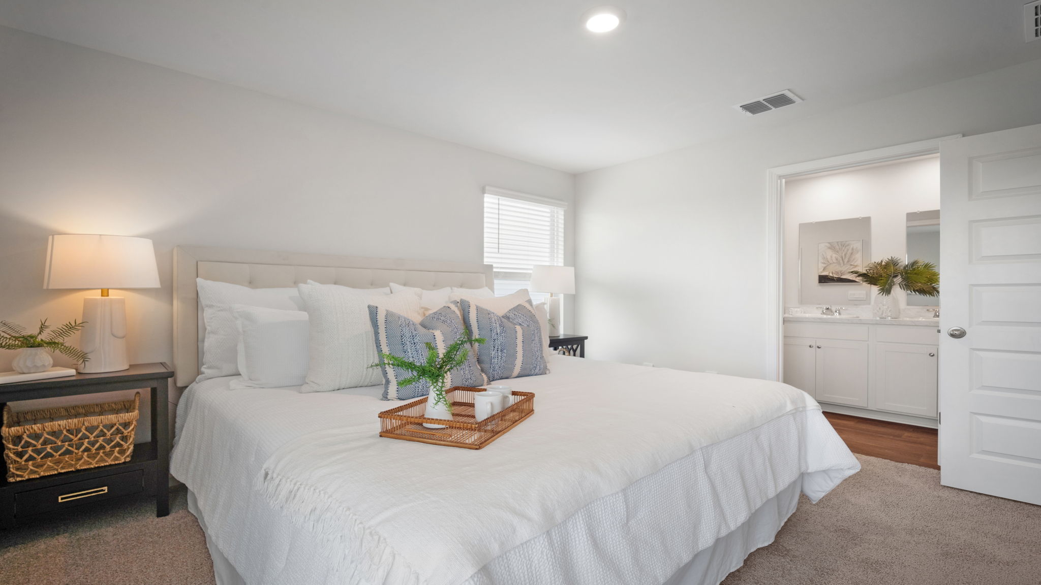 Primary bedroom decorated with a bed and a side table