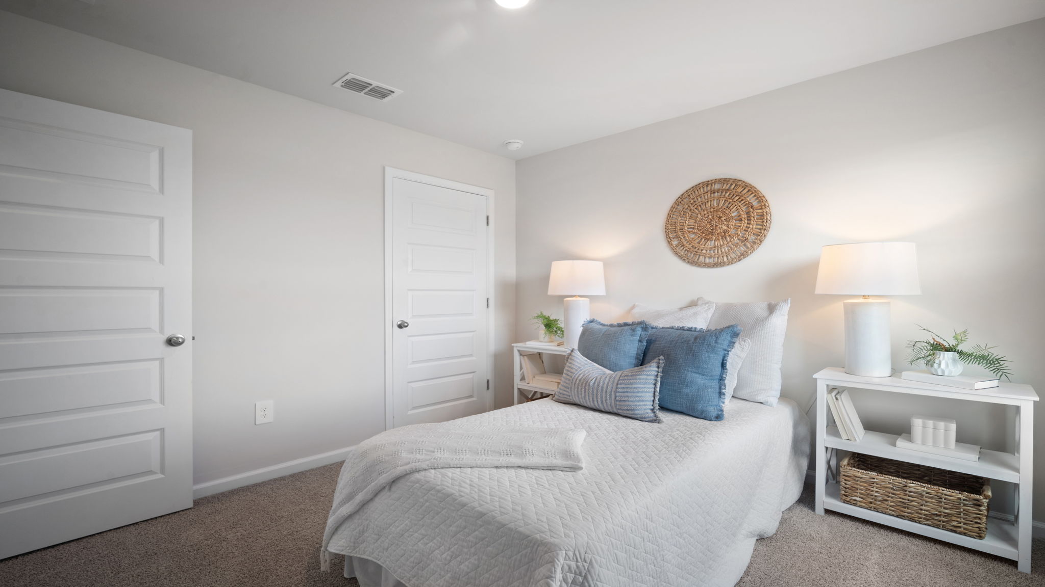 Guest bedroom decorated with a bed and a side table