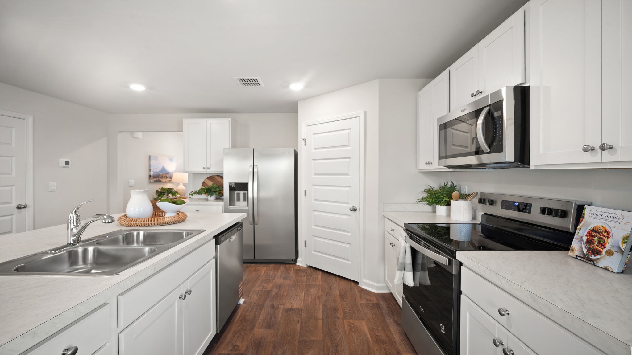 Kitchen walkway with counters on both sides
