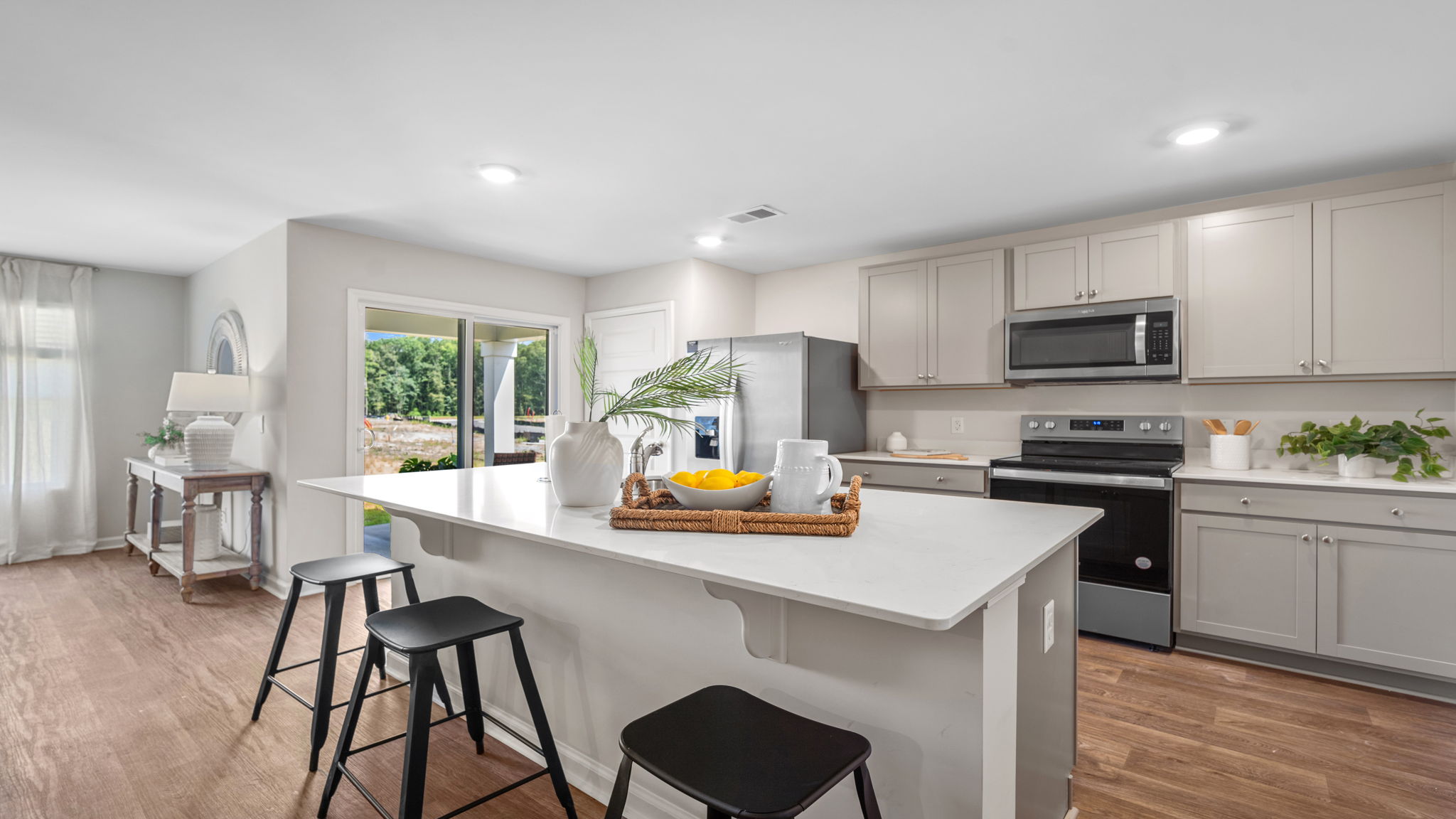 Kitchen island view of the living area and the sliding glass door view to the right