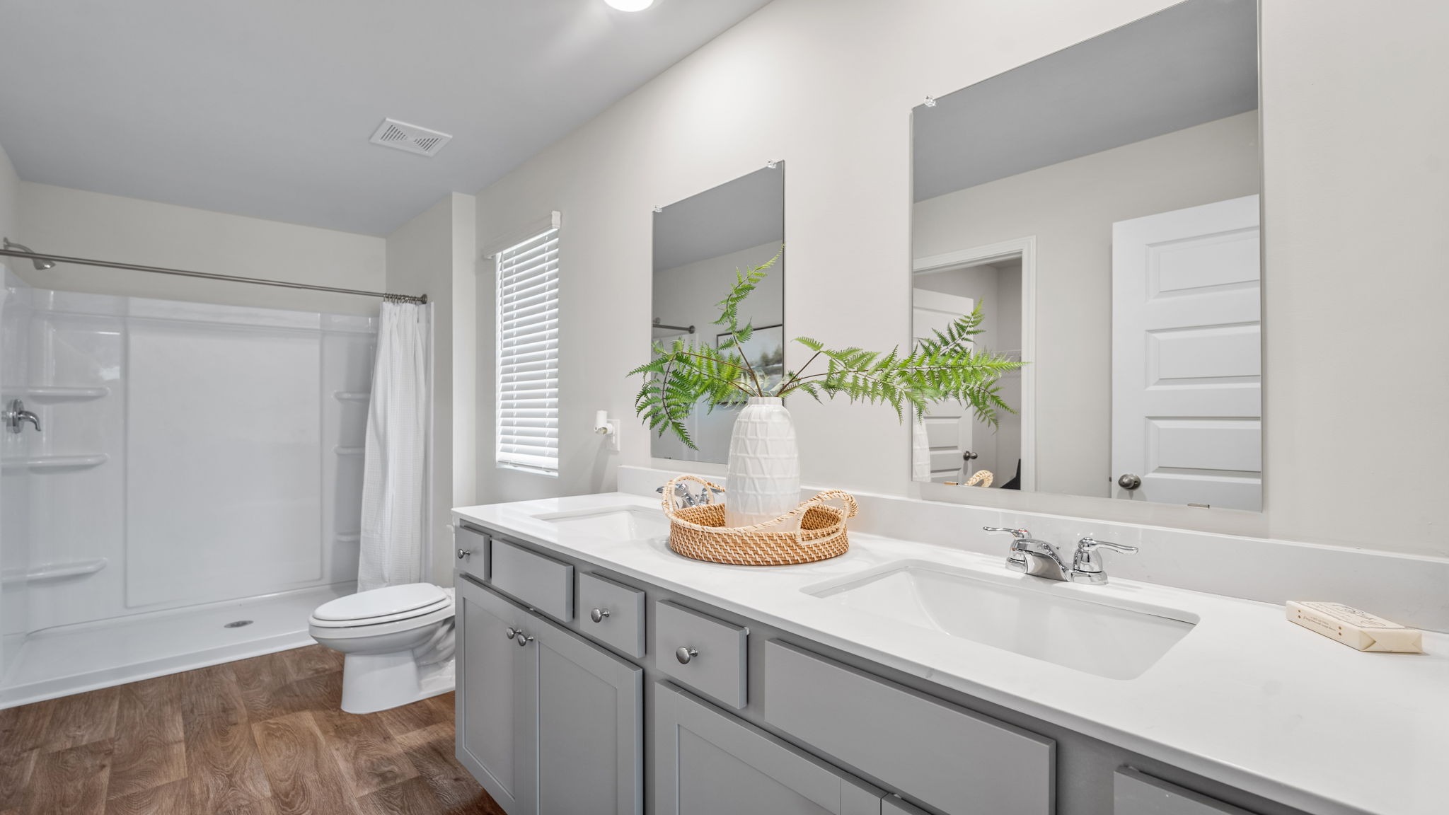 Spa-inspired primary bathroom in the Kerry floor plan featuring dual vanities, a walk-in shower, and modern finishes.