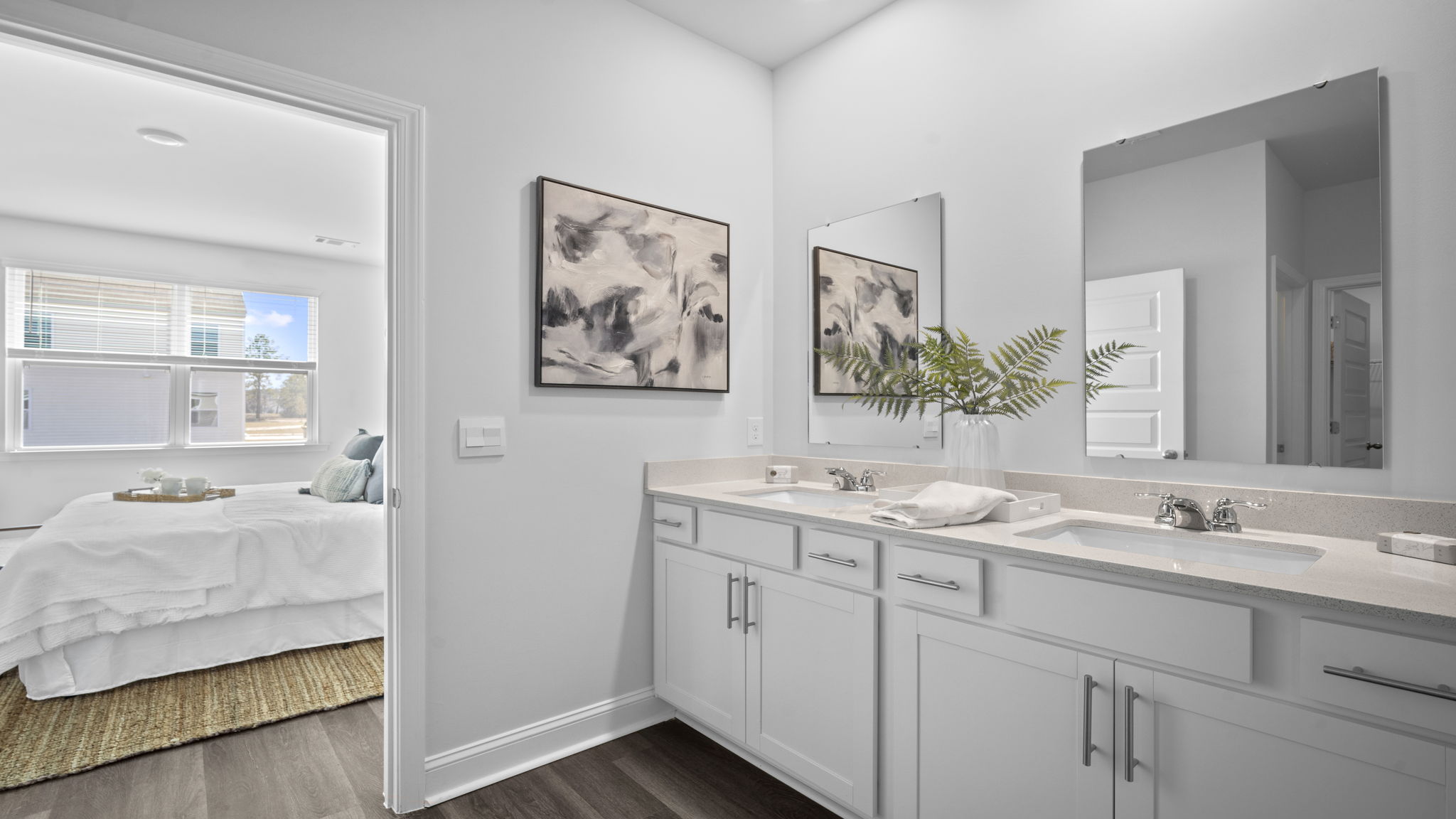 Primary bathroom with double vanities and a stand-up shower