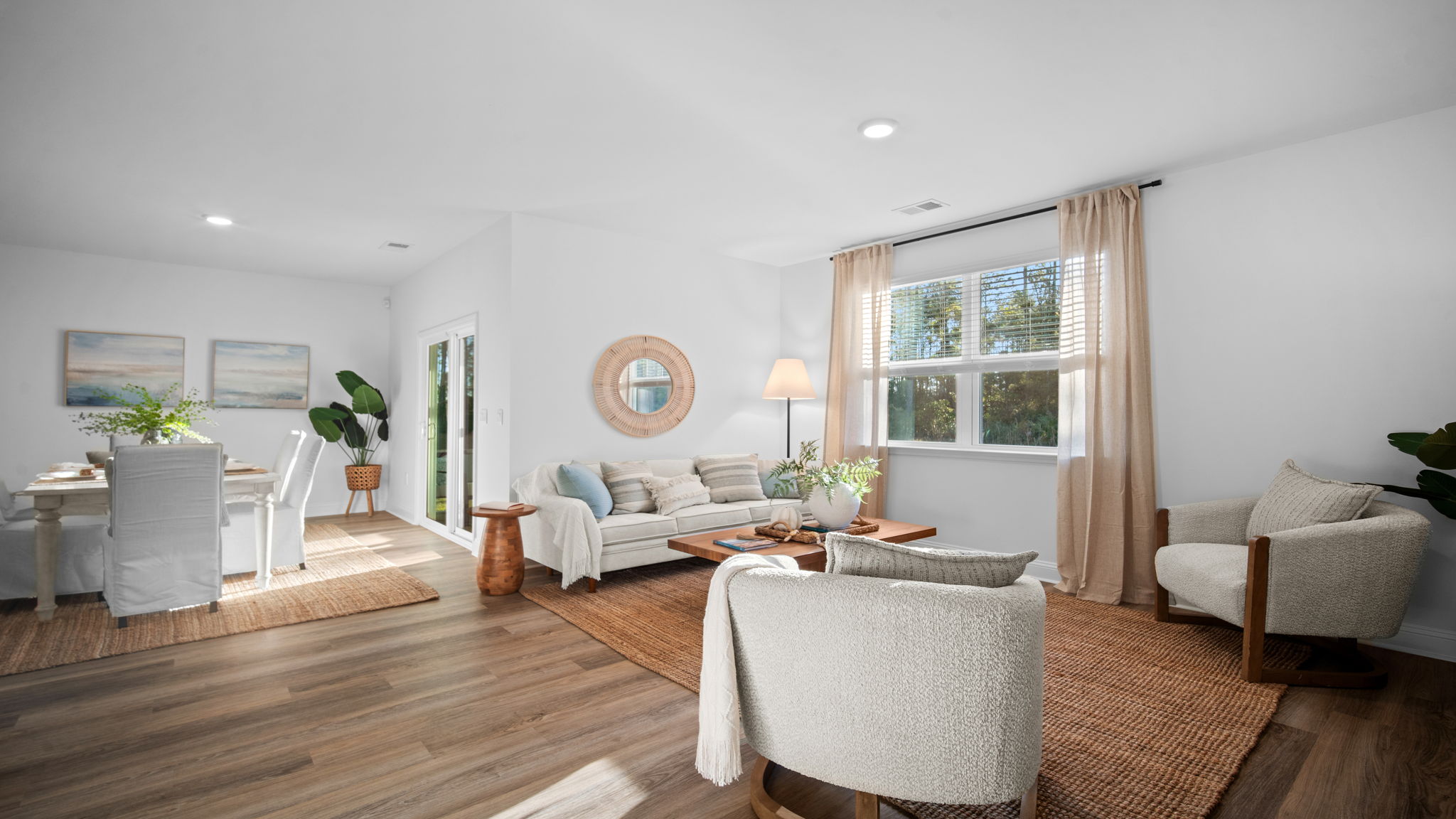 Spacious living room in the Cali floor plan at Rice Hope featuring an open-concept design that seamlessly connects to the kitchen and dining area for effortless entertaining.