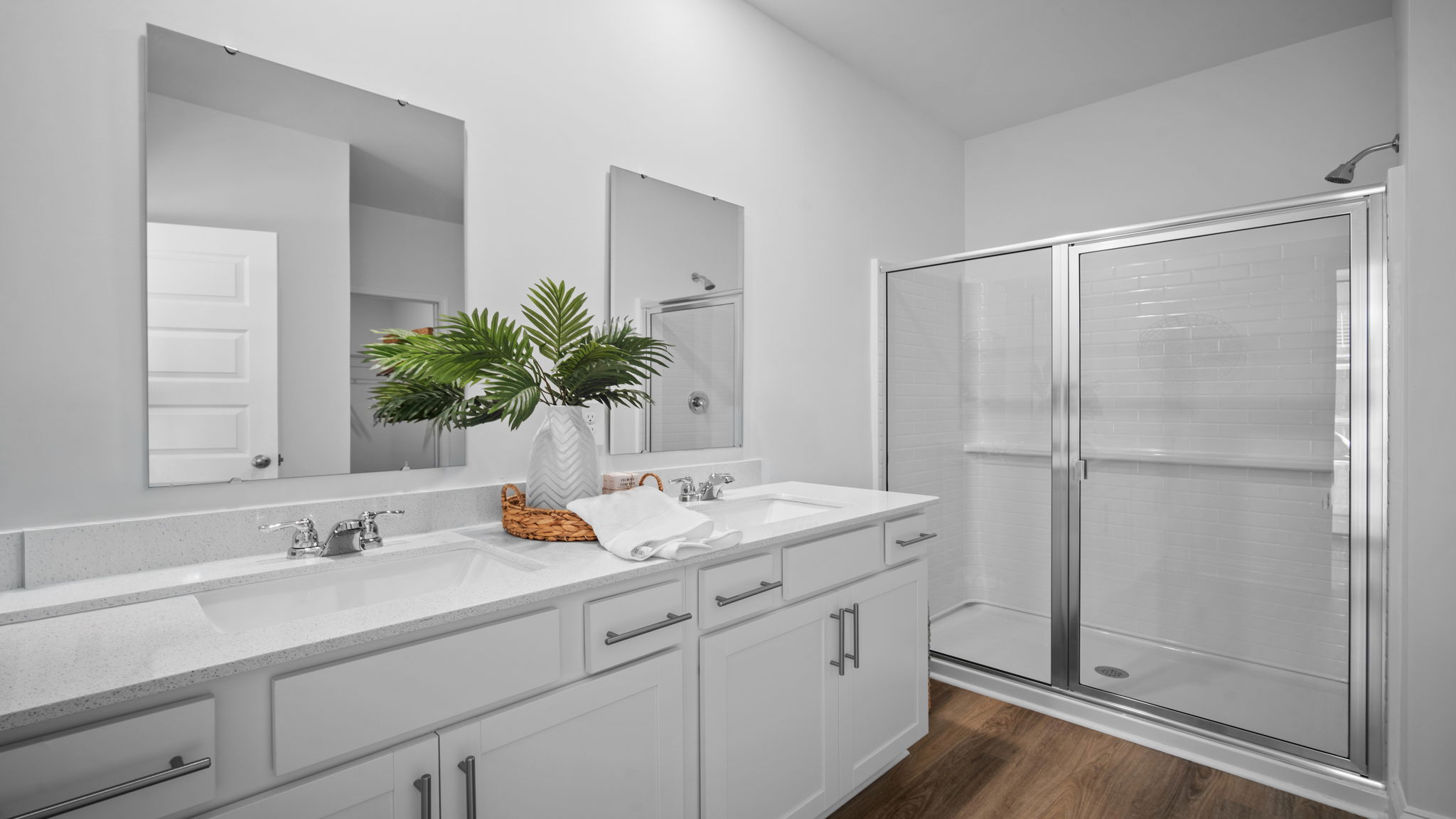 Luxurious primary bathroom in the Cali floor plan with dual-sink vanity, walk-in shower, and modern finishes.