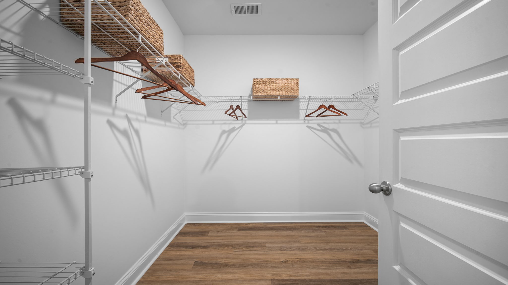 Large walk-in closet in the Cali primary suite providing abundant storage and organization space.