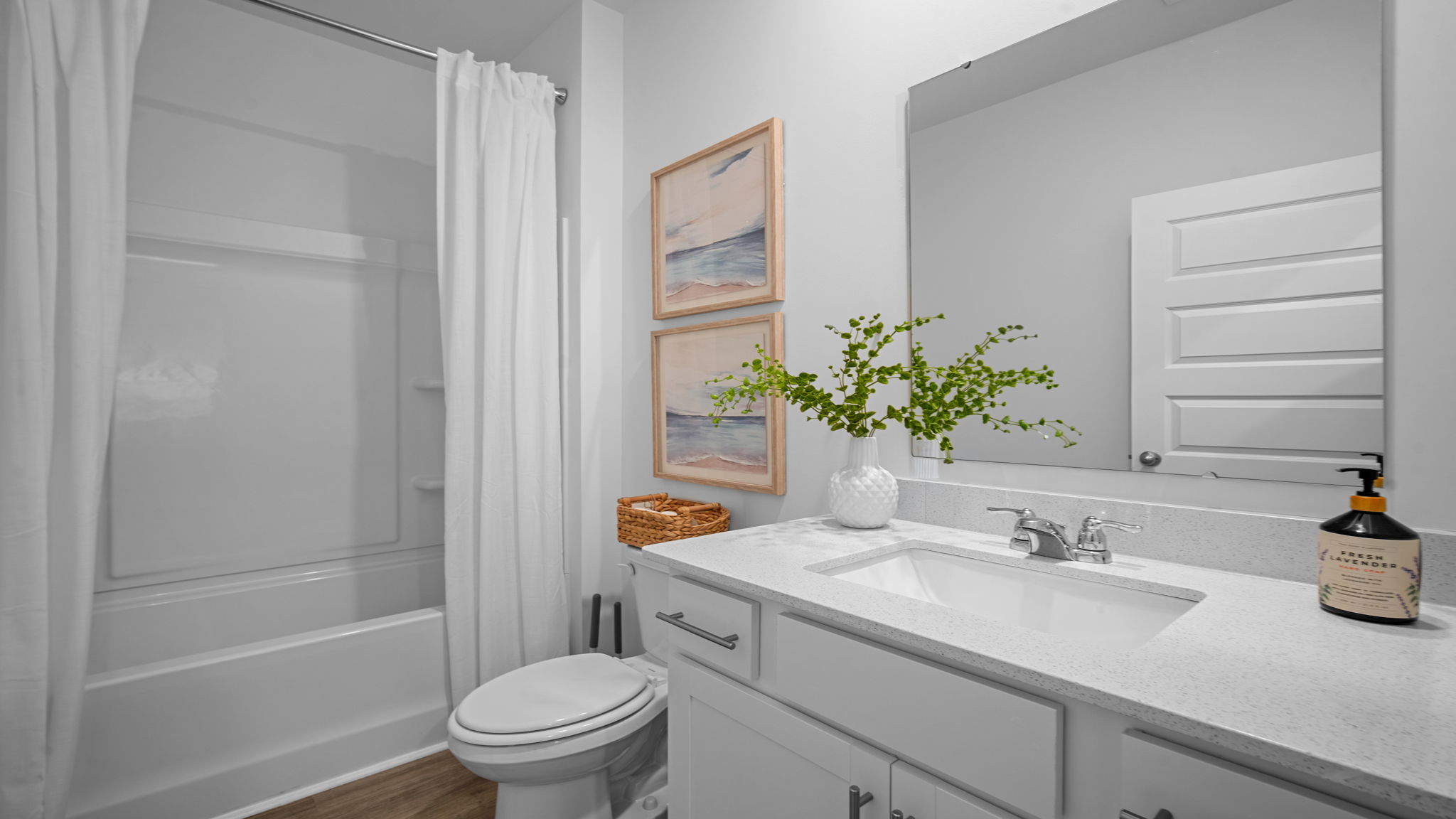 Full hall bathroom in the Cali floor plan conveniently located near secondary bedrooms for family and guests.