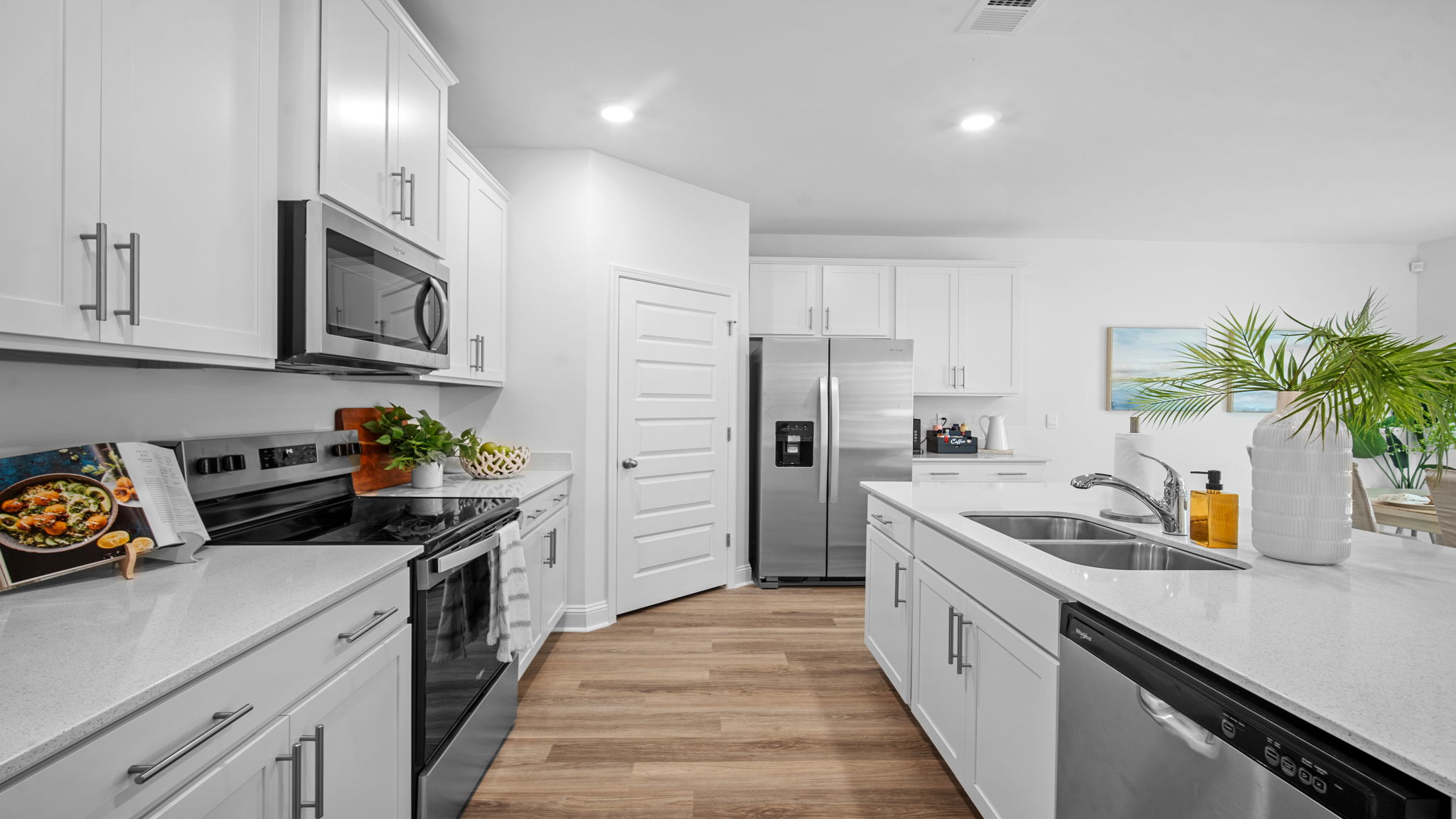 Open-concept kitchen in the Cali home at Rice Hope with abundant cabinet storage, large island seating, and modern finishes.