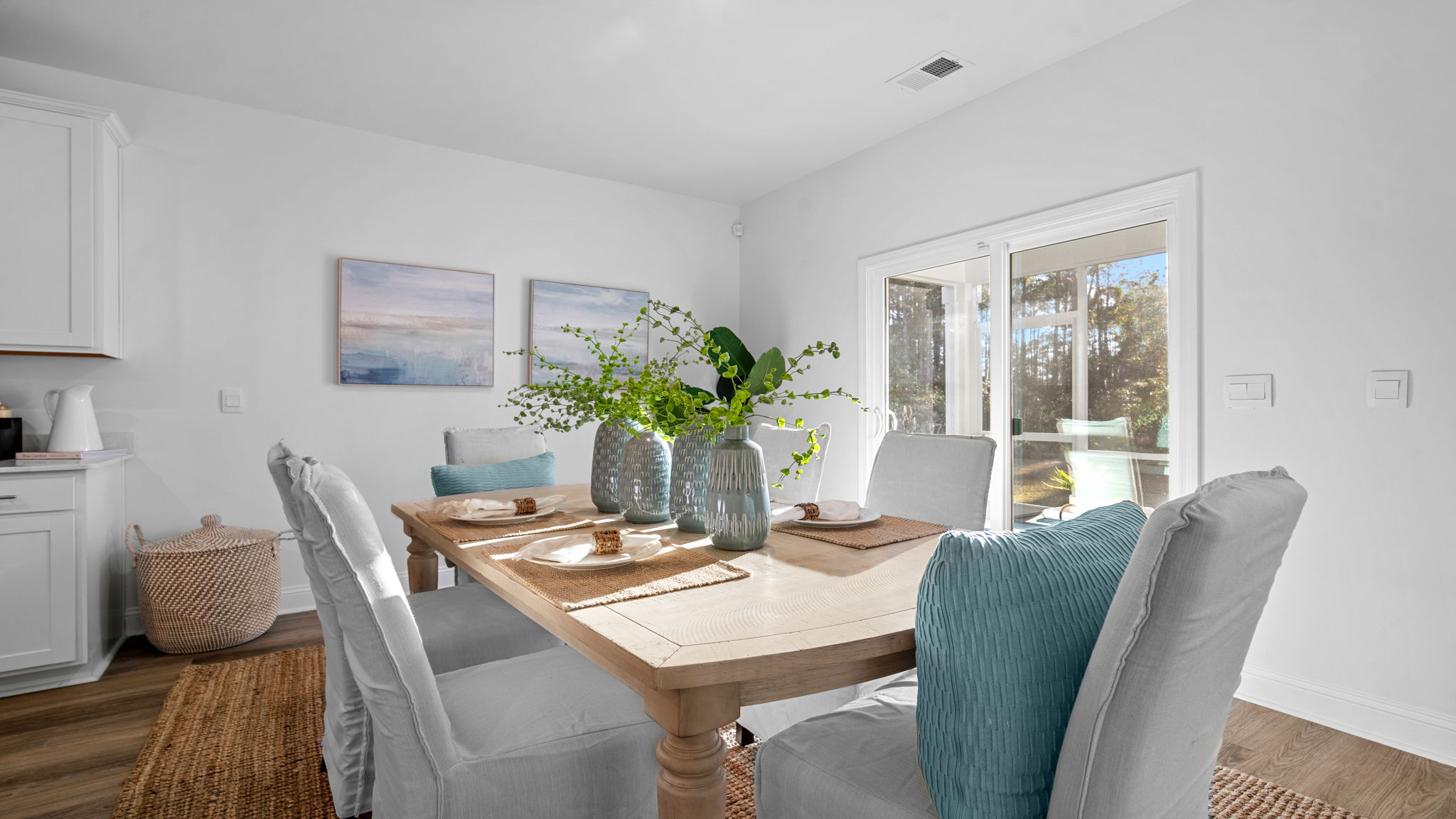 Open dining space in the Cali home by D.R. Horton offering comfortable gathering space with views of the main living area.