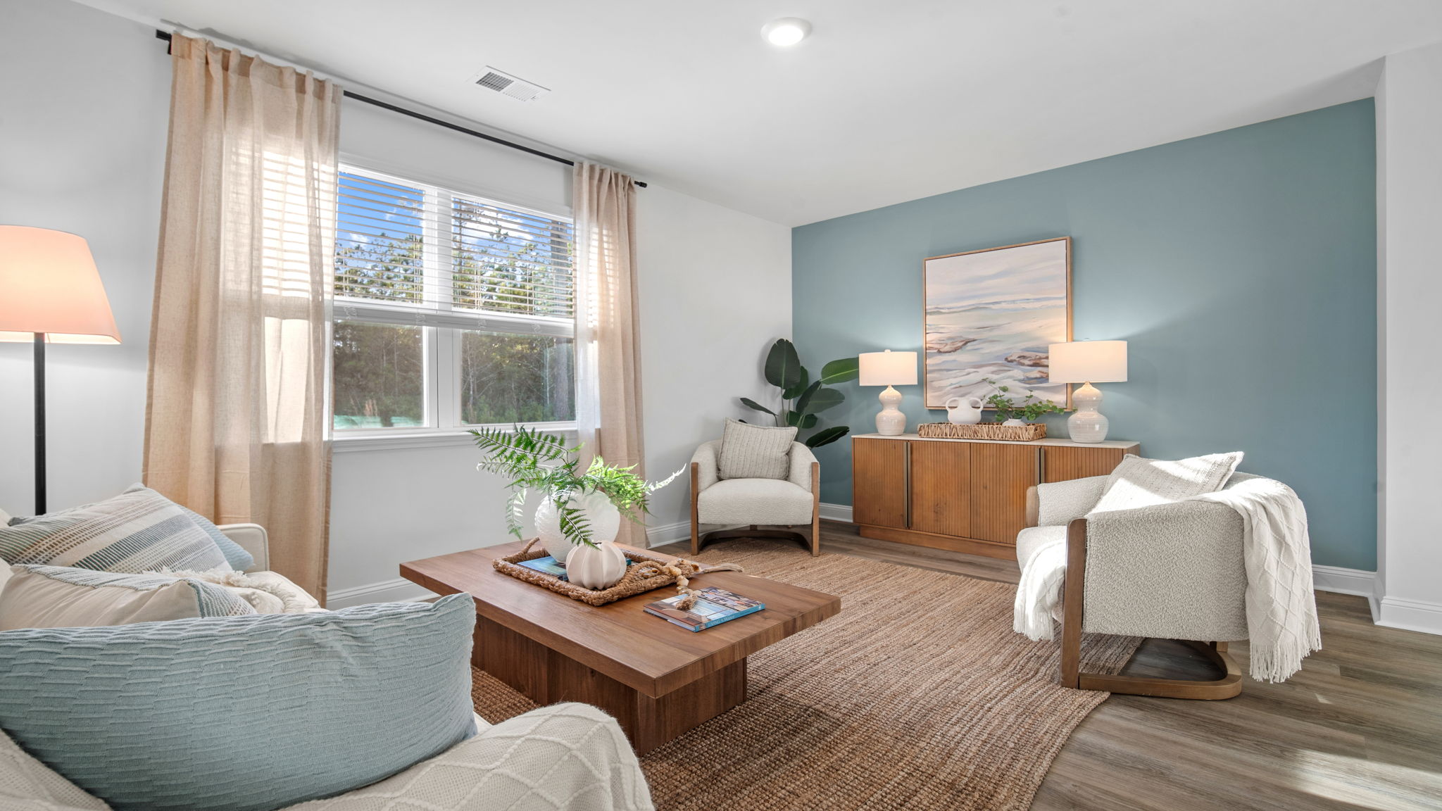 Spacious family room in the Cali floor plan featuring open-concept design, natural light, and easy access to the kitchen and dining area.