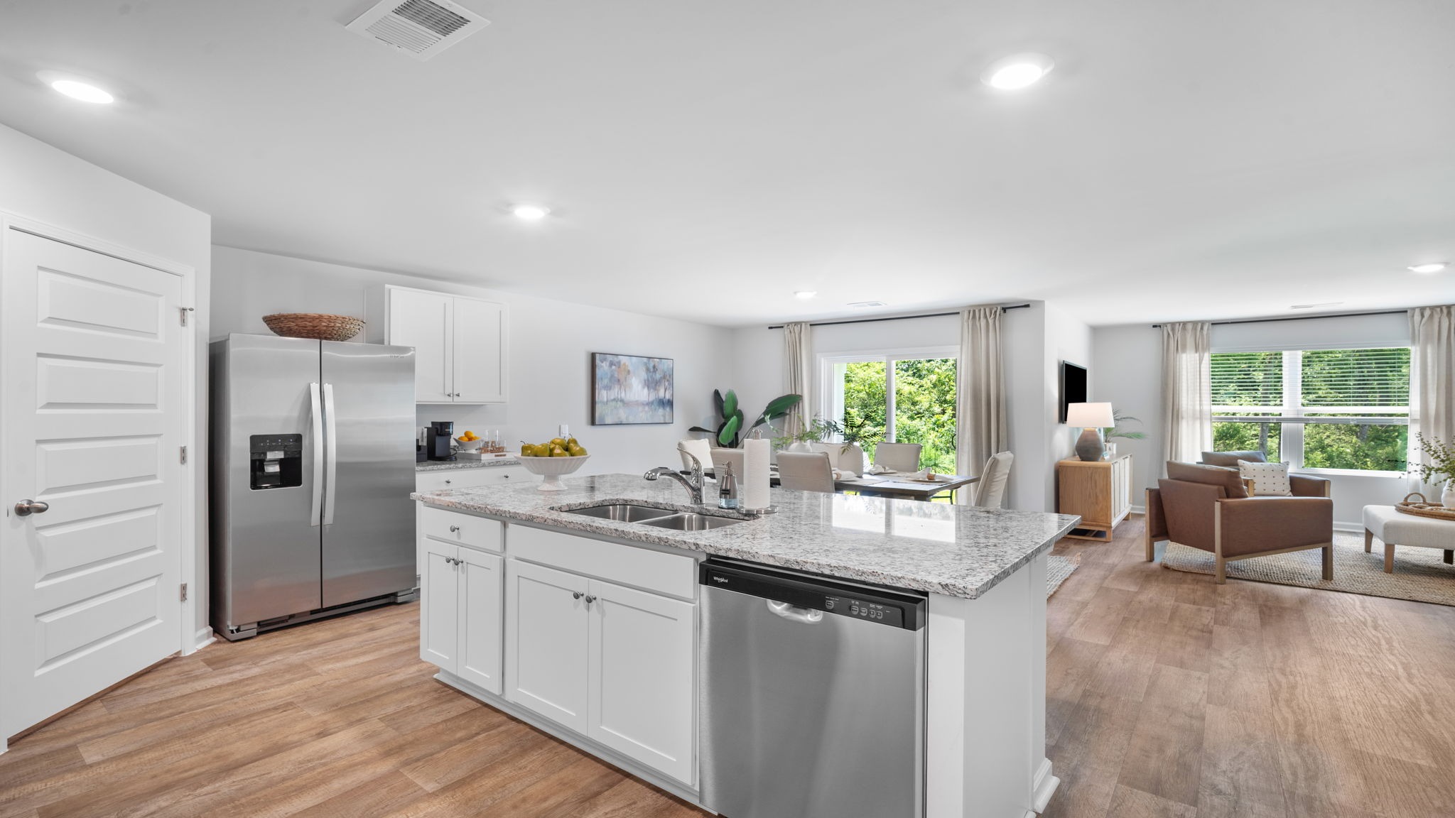 Spacious kitchen in the Cali floorplan at Rice Hope featuring stainless steel appliances, a large center island, walk-in pantry, and open-concept design that flows seamlessly into the dining and family room.